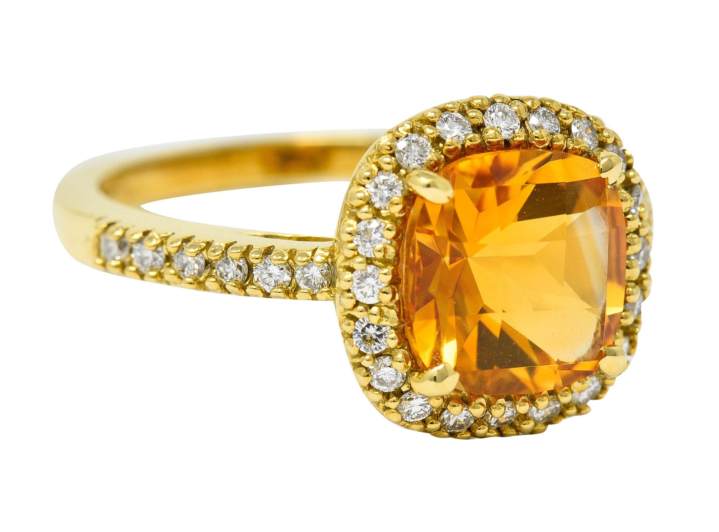 Cluster ring centers a 8.0 mm checkerboard cushion cut citrine

Transparent and saturated orange in color

With a cushion diamond halo and shoulder accents

Round brilliant cut diamonds weigh in total approximately 0.50 carat - G/H color with SI
