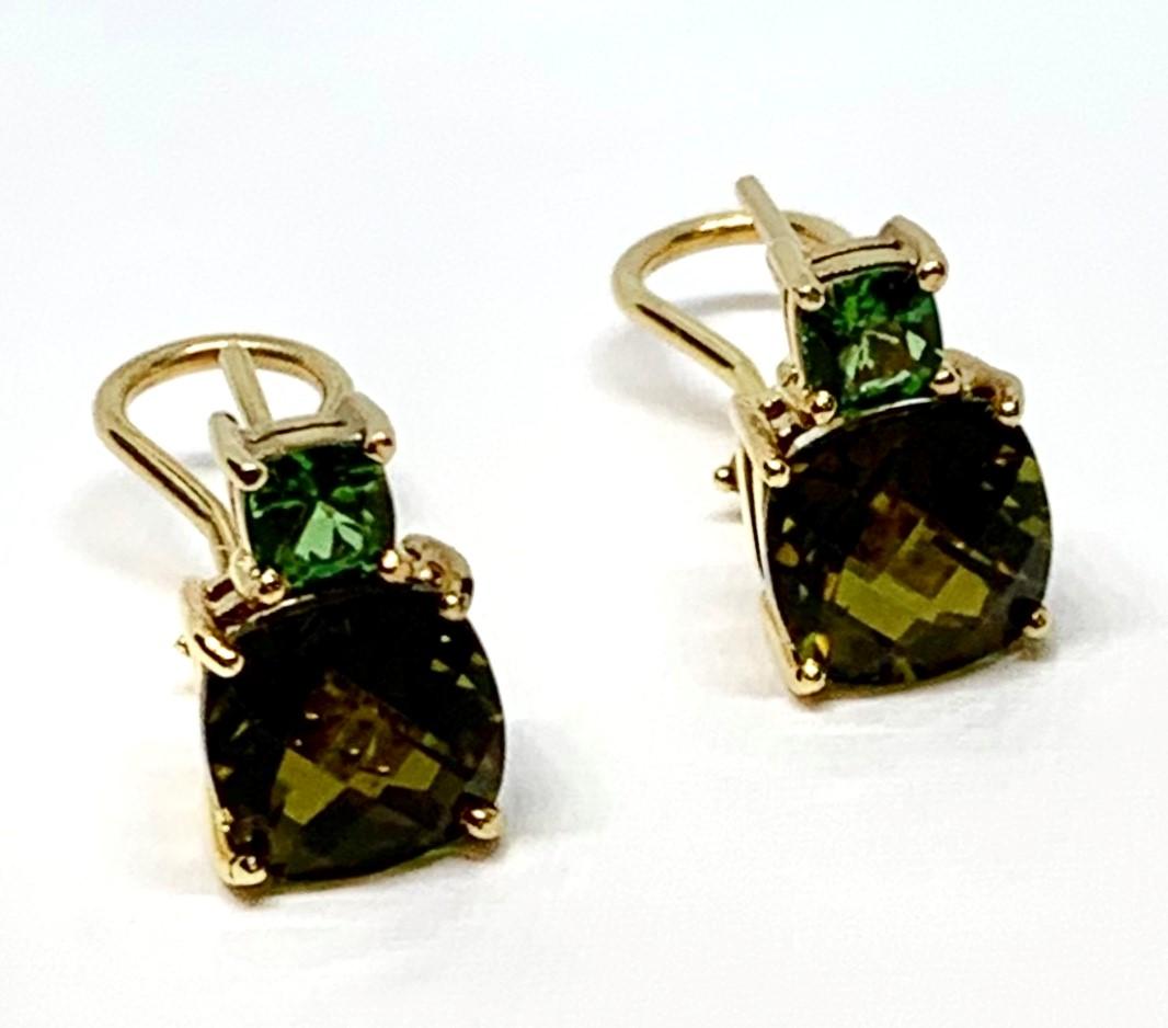 These earrings are a beautiful combination of bright and muted colors, featuring bright, spearmint-green, tsavorite garnets and mossy olive green tourmalines set in 18k yellow gold. The tourmalines have been faceted with an unusual and eye-catching