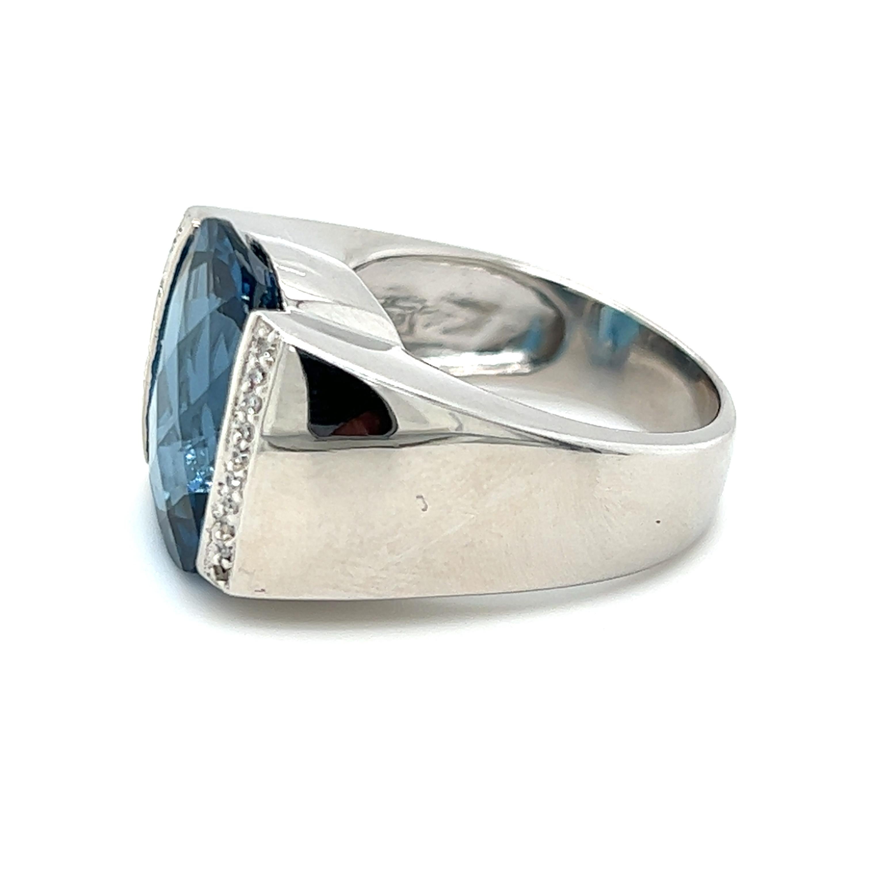 One 14 karat white gold ring, designed by John C. Rinker,  set with one 16.15x11.5mm checkerboard cut London blue topaz stone, approximately 12.00 carat and twenty (20) single cut diamonds, approximately 0.10 carat total weight with matching I/J