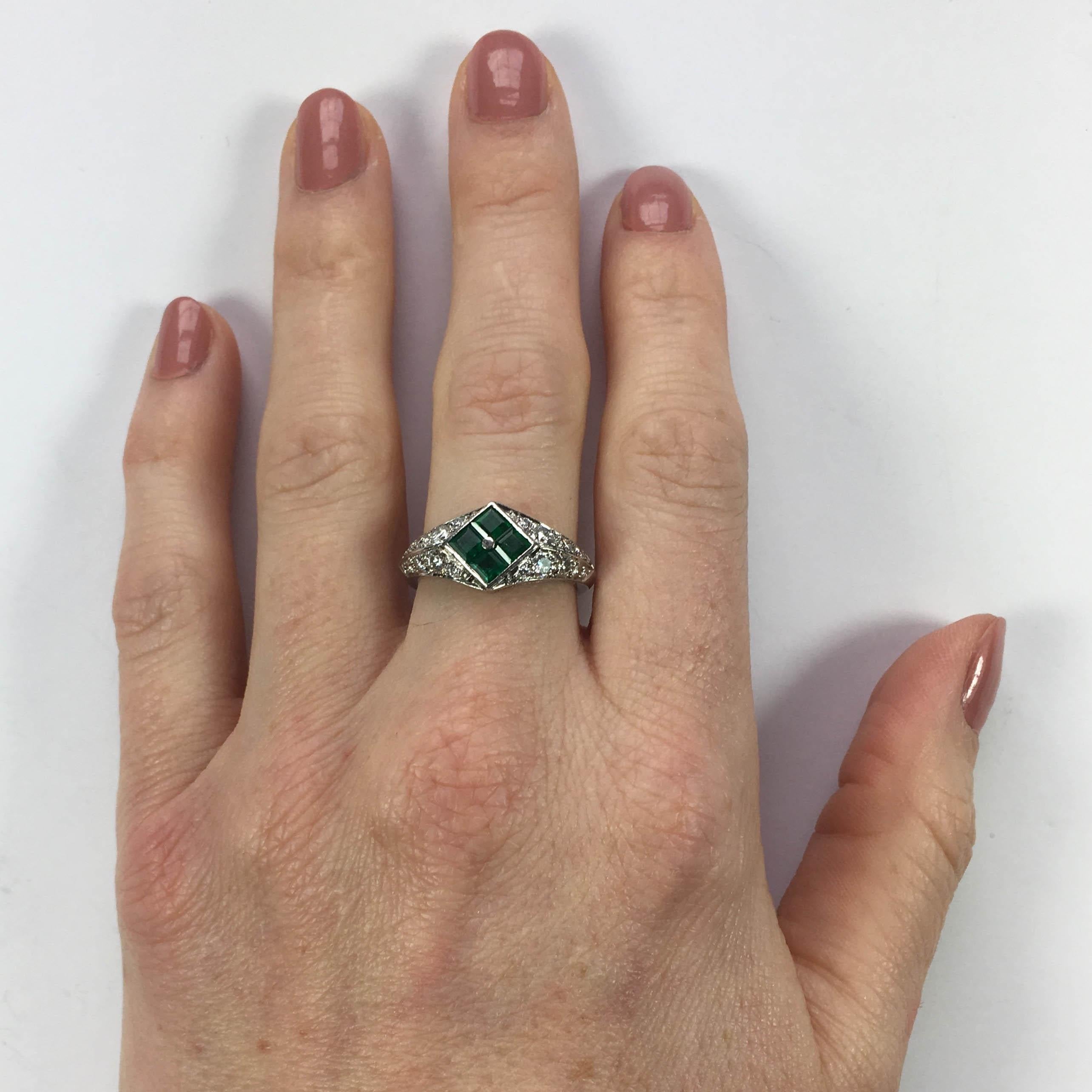 A smart platinum ring pave-set with 20 round brilliant-cut diamonds (E colour, VS clarity) rising to a checkerboard panel of invisibly-set square step-cut natural emeralds.  The ring is exquisitely made and shows a high level of craftsmanship in the