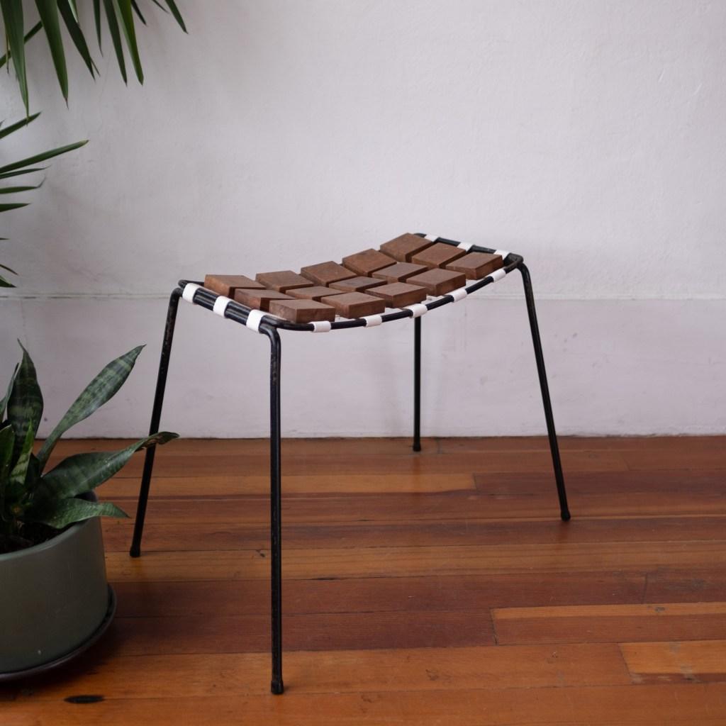 Checkerboard Collection stool designed in 1953 by New York-based designer Maxwell Yellen. Newspapers of the time described the walnut block and cotton strap construction “novel wooden upholstery.” Yellen was quoted as saying his technique would