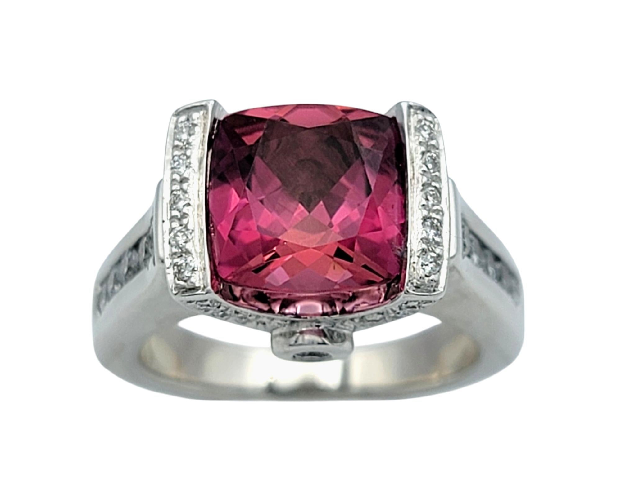 Ring Size: 6 

This exquisite pink tourmaline and diamond ring is a bold statement of elegance and luxury. The centerpiece features a vibrant checkered cushion-cut pink tourmaline, radiating a rich and captivating hue that exudes sophistication.