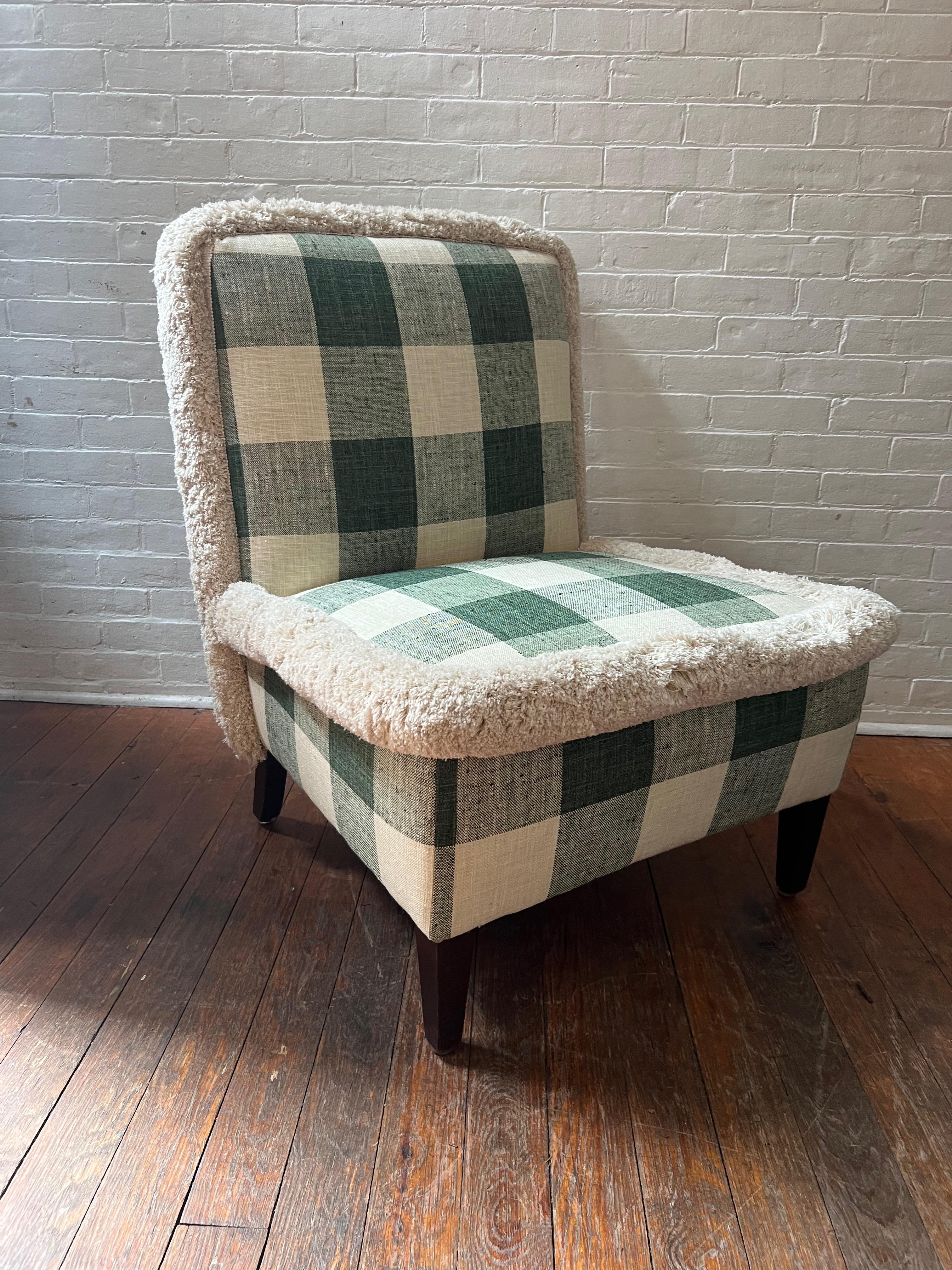 This classic slipper chair silhouette has been modernized with a jumbo check upholstery and jumbo fringe by Samuel and Sons. The silhouette is great in small spaces, an accent chair or in a bedroom.