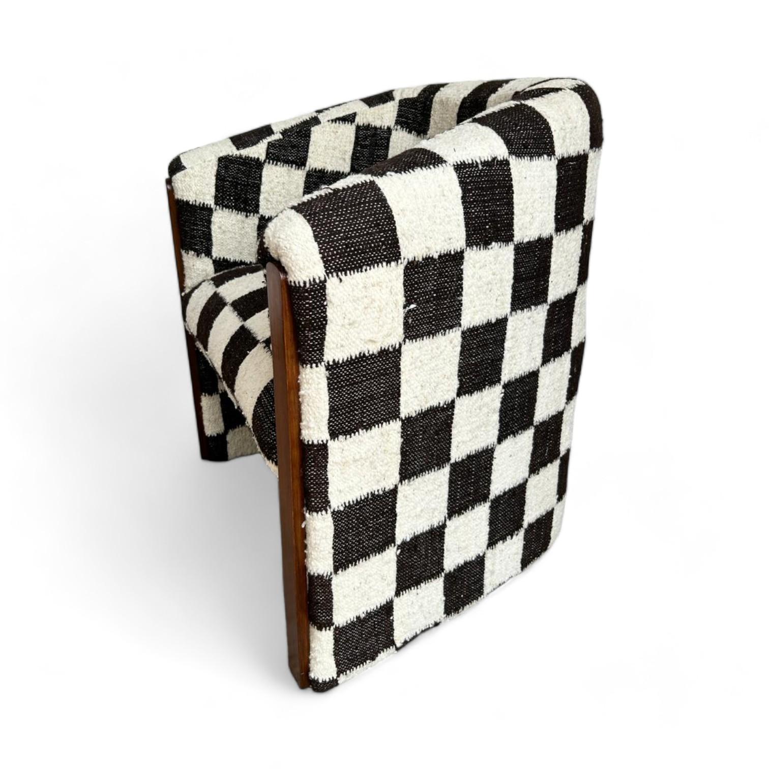 The Checkered Wool Chair explores functionality, shape, and craft. Artisans in Momostenango, Guatemala weaved each piece in a pedal loom using hand-spun wool. Each piece is upholstered in Guatemala city, using pinewood. Through your purchase, you