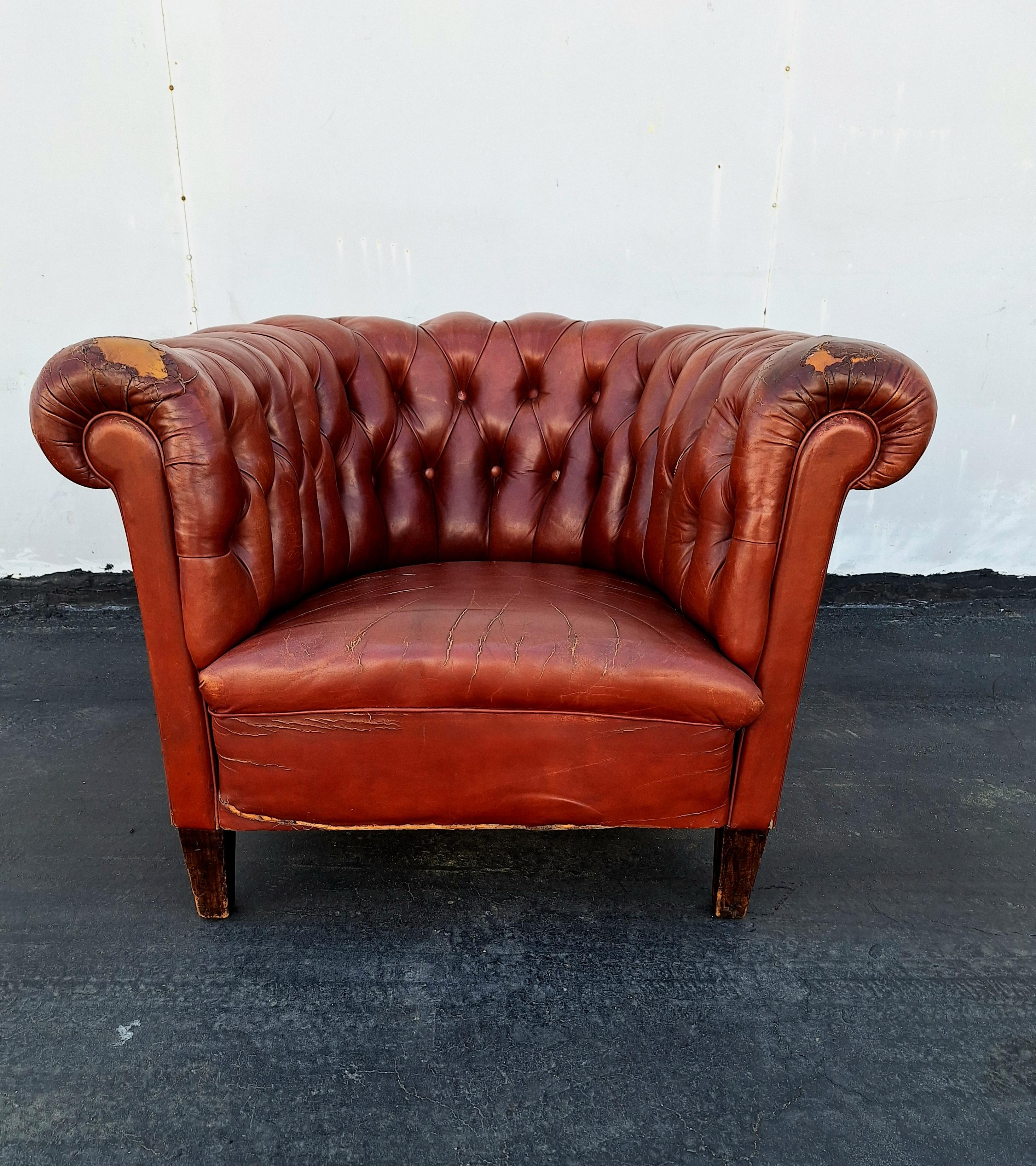 A good quality early 20th century, brown leather club armchair Chesterfield. Original hand dyed  brown leather. This Cesterfield is horse hair filled, with button-back upholstery. standing on the wooden legs with a wonderful patina and very