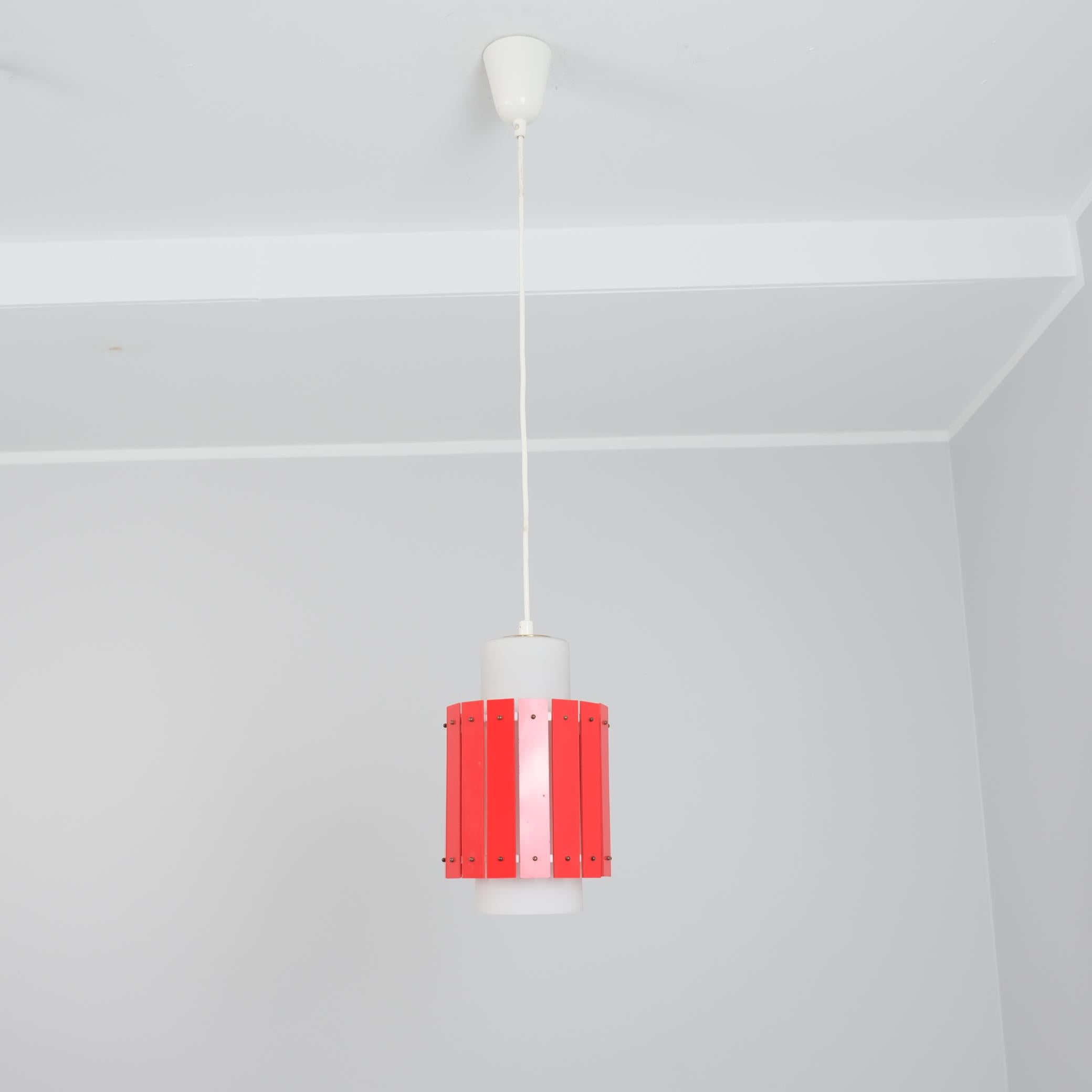 Un pendente da soffitto allegro e colorato di Maria Lindeman per Idman. Già disegnata alla fine degli anni '50 e presente nel catalogo Idman del 1961, questa lampada combina un paralume in vetro smerigliato con un paralume esterno in plastica dura
