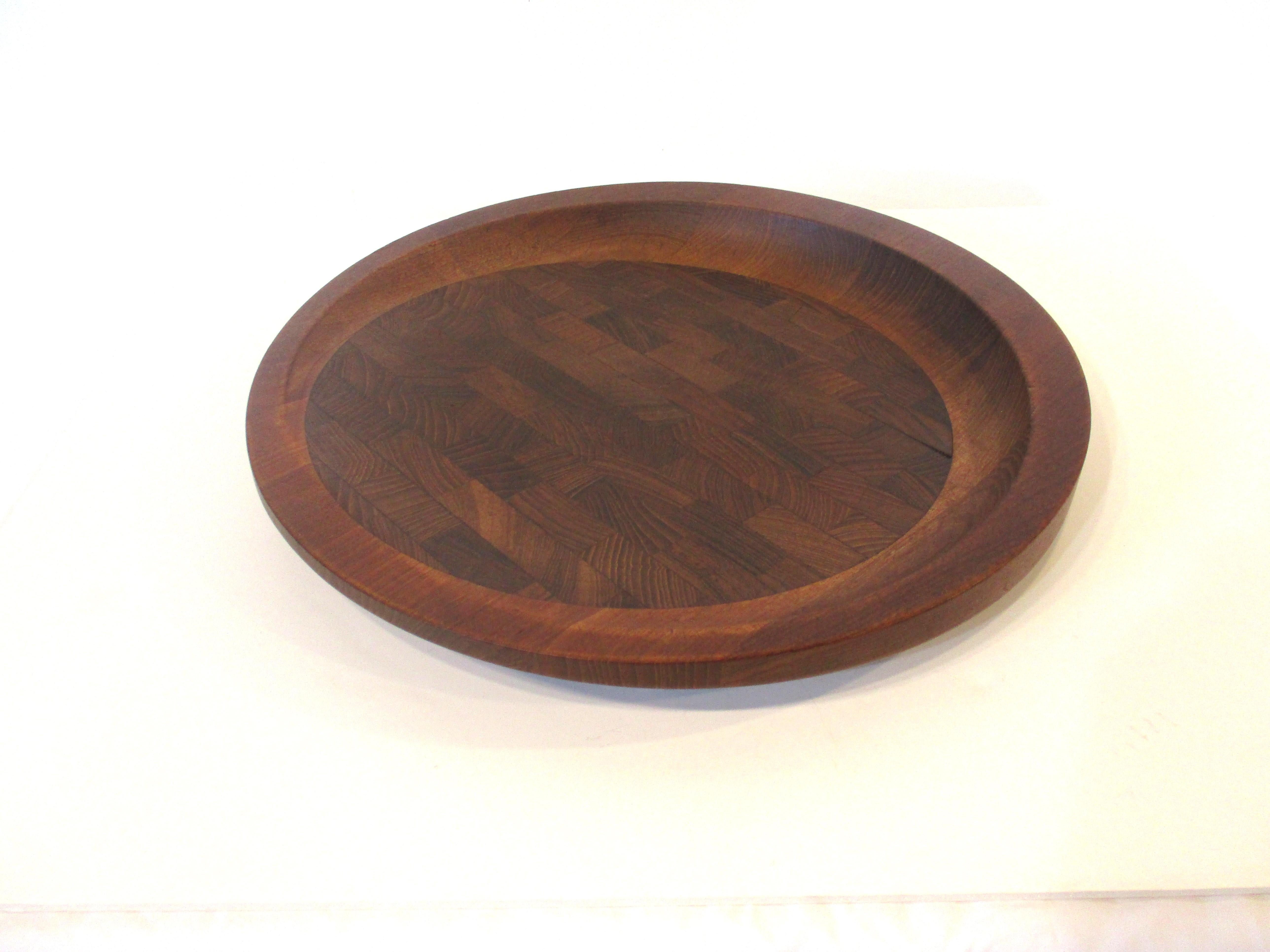 A very well crafted teakwood serving cheese / charcuterie board with lifted end and rim forming a nice design astatic . Not marked but attributed to Dansk made in Denmark.