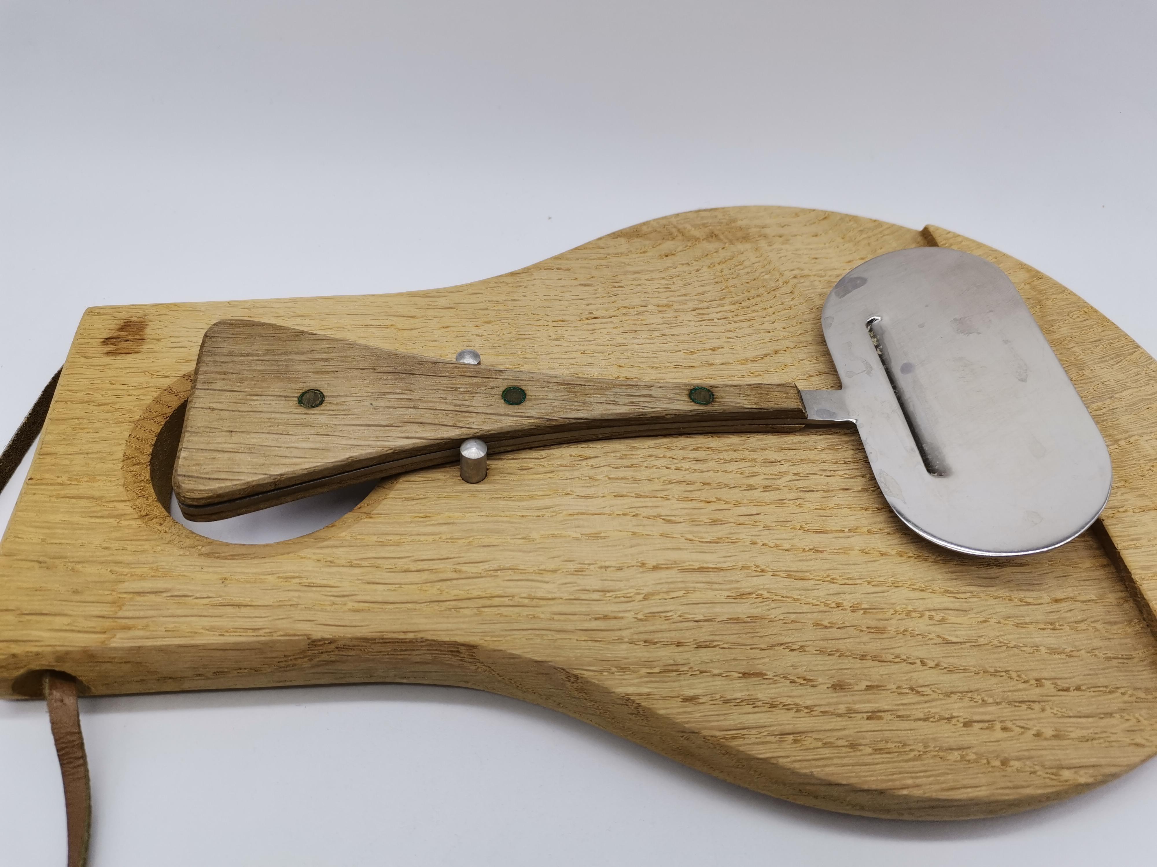 A cheese slicer and a wooden board Austria.