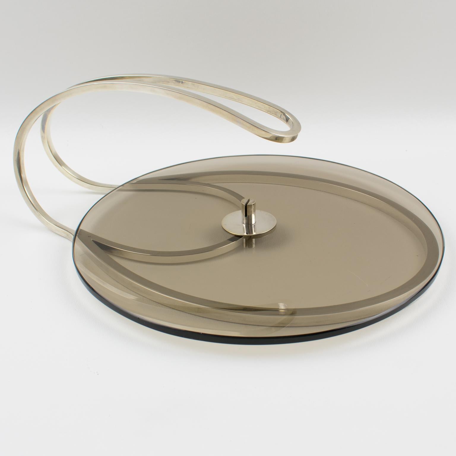 A stunning 1970s modernist cheese display board, serving tray, or platter crafted by French Silversmith Maison Produx, Paris. The thick smoked glass base has a large silver plate handle. This neat design has a typical Machine Age flair. The legal