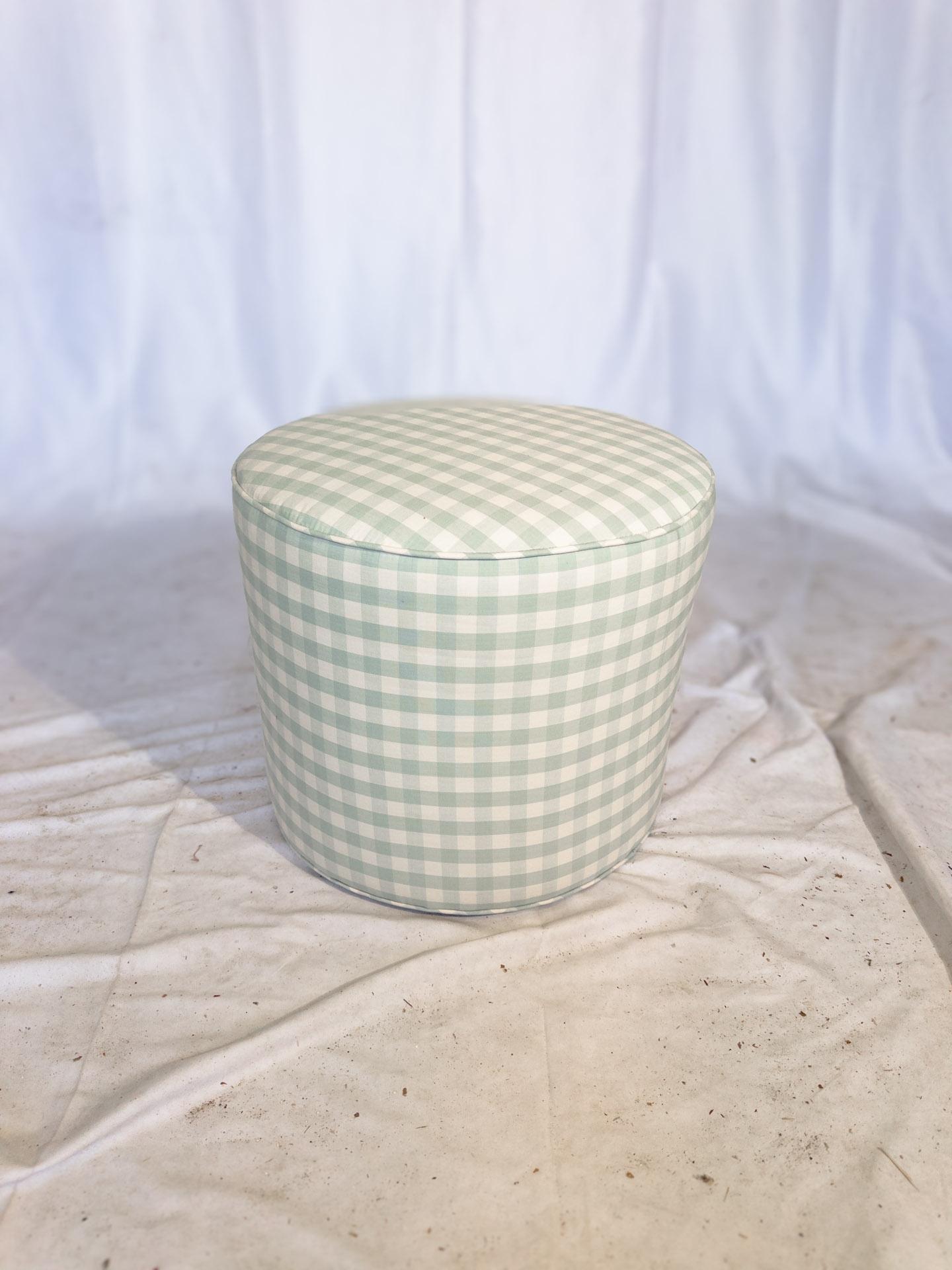 The Chelsea Checkerboard Round Ottoman is a delightful fusion of classic elegance and contemporary flair. Its round shape and plush cushioning provide both comfort and versatility, making it a perfect addition to any living space. Adorned in a