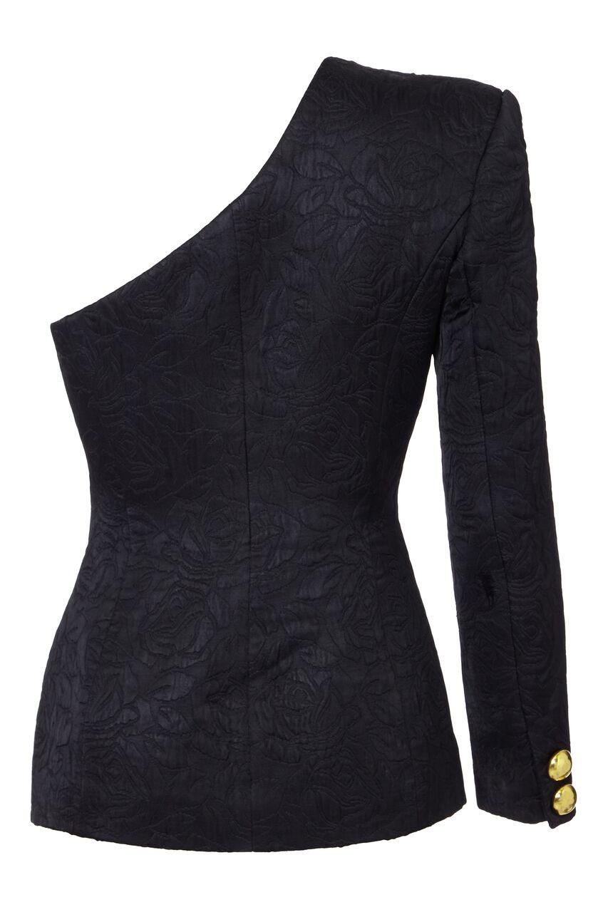 This arresting 1980s black asymmetrical jacket by Catherine Walker for The Chelsea Design Company is in excellent condition and is a statement piece of exceptional quality. The black sateen fabric is embossed with a climbing rose motif and has a