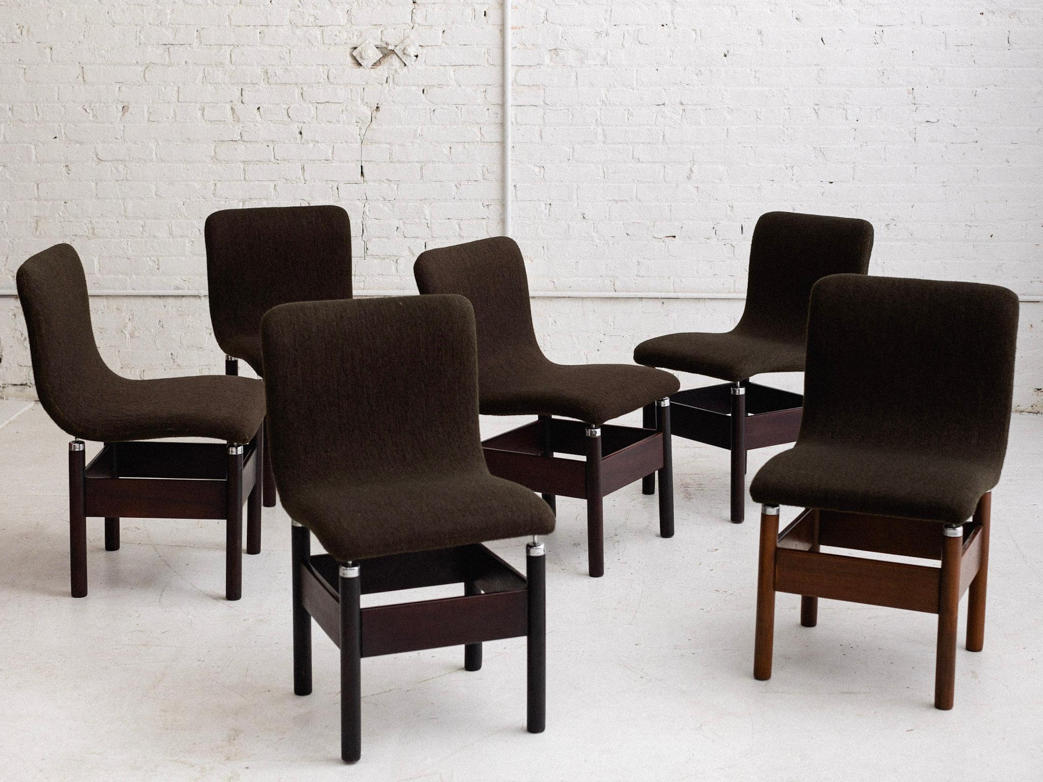 A mid century set of 6 dining chairs by Vittorio Introini for Saporiti. Dark walnut finished wood frames with original wool upholstery and chrome accents. Variations in wood color from chair to chair. Sourced in Northern Italy.