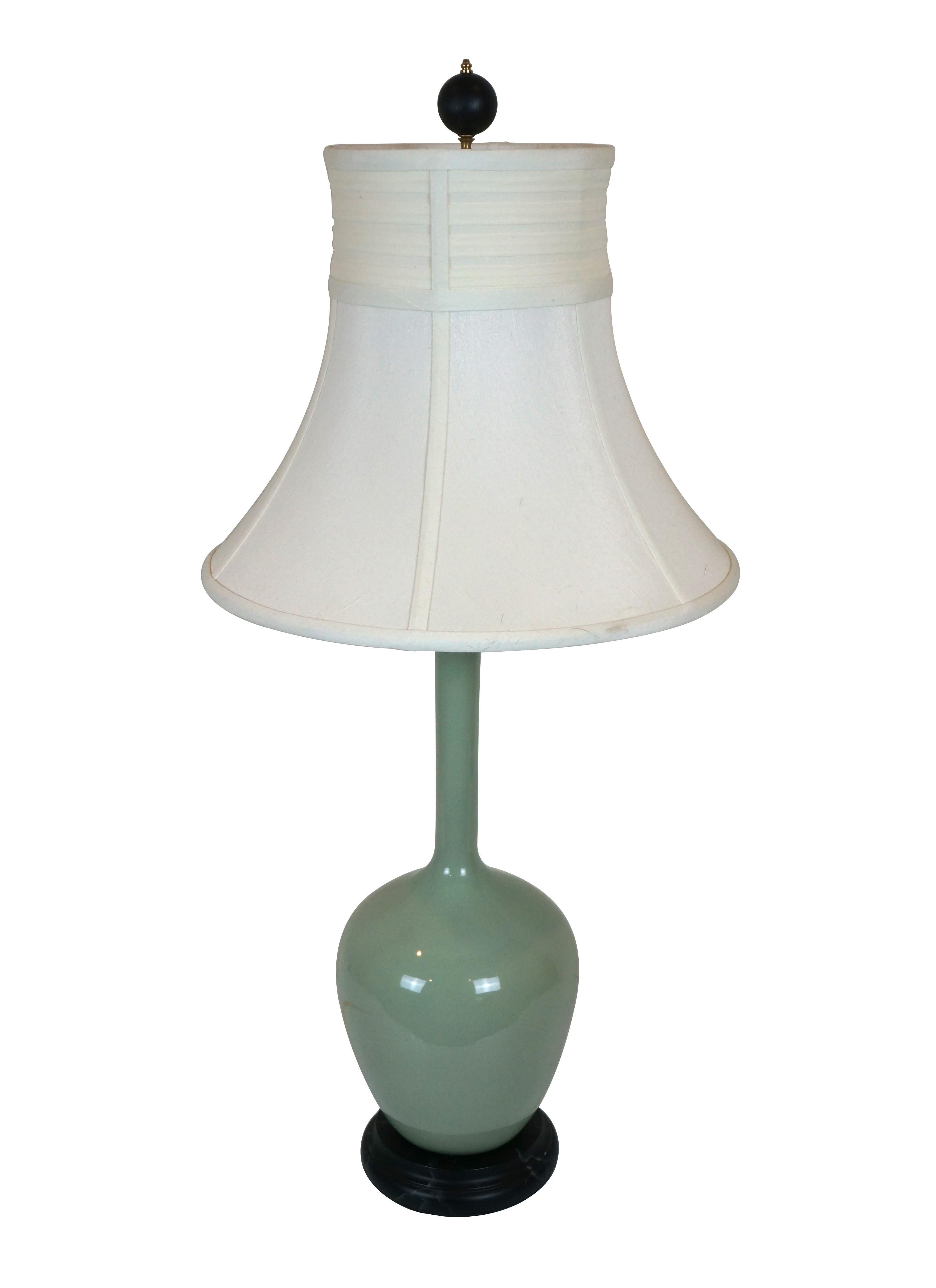 Chelsea House ceramic table lamp glazed in a soft celadon green with black faux marble base and brass hardware. Includes harp, black wood orb finial and a stylish white fabric shade. Made in China.

Dimensions:
7
