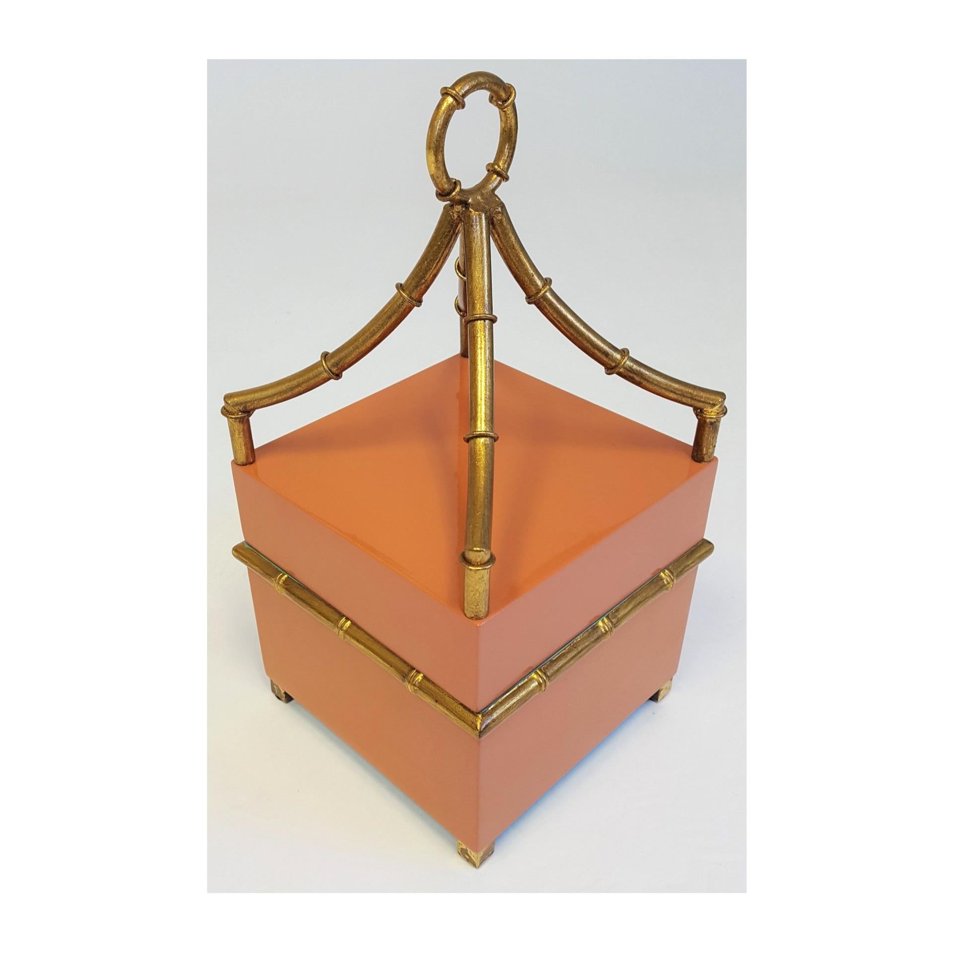 Beautiful decorative box that would be a statement on a bookshelf, console or coffee table. Orange with gold finish on bamboo detail and aqua on the inside. Made by Chelsea House, a NC manufacturer of high-end accessories, lighting and furniture.