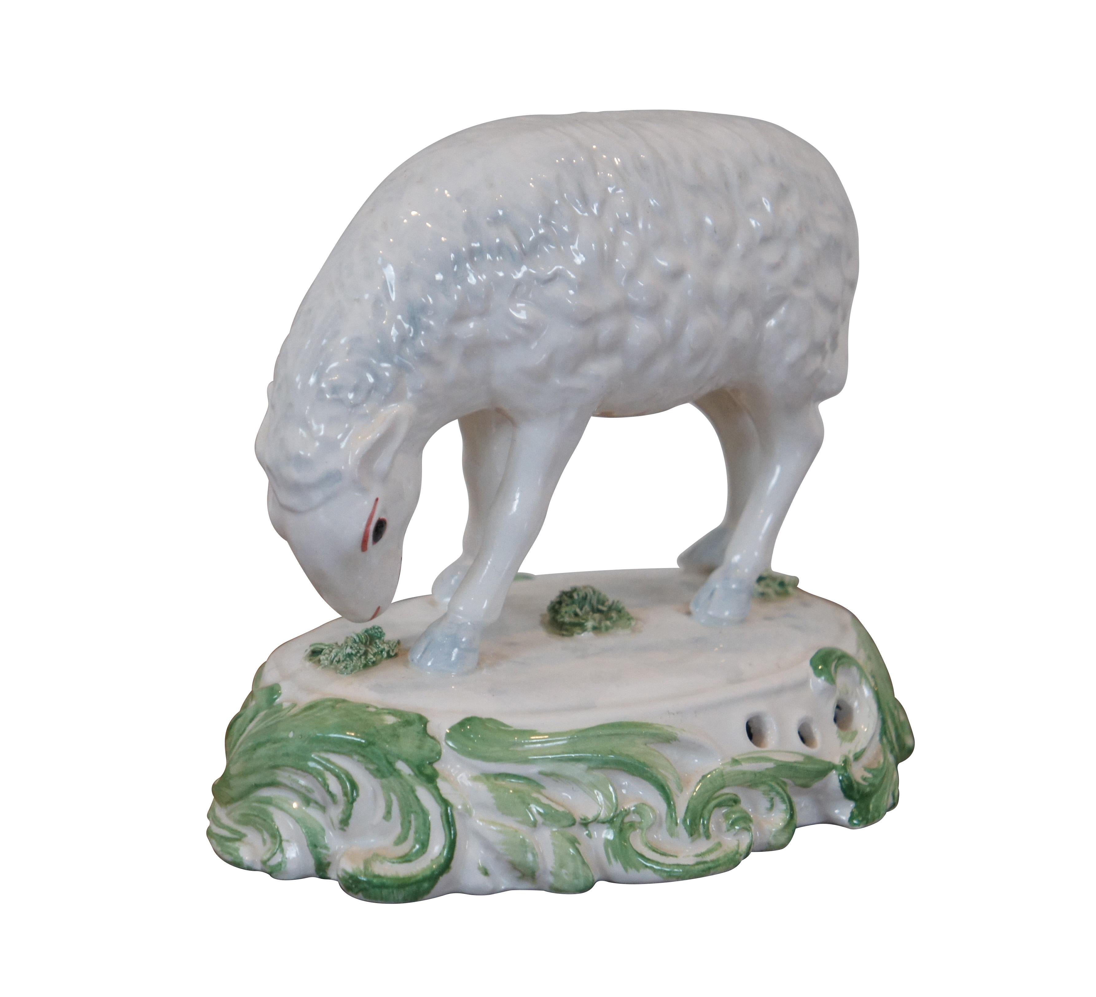 Vintage Chelsea House Port Royal hand painted porcelain figurine in the shape of a sheep / lamb grazing in a field. White with green foliate details. In the style of 19th century Staffordshire figurines. Made in Italy.

Dimensions:
6.75” x 4.75” x