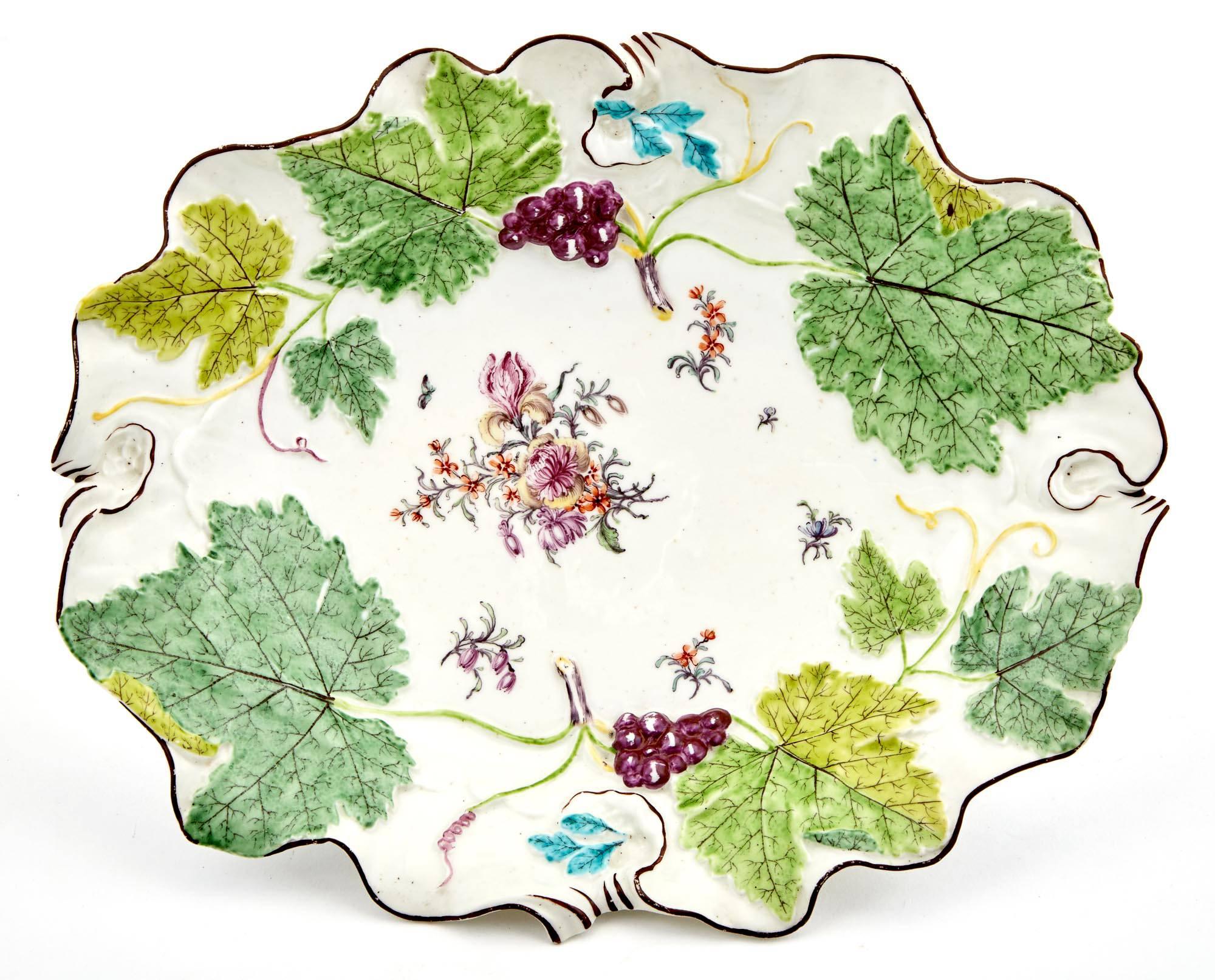 Chelsea porcelain red anchor period vine leaf botanical dish, 
Red Anchor period,
circa 1755-1758.

The deep shaped botanical porcelain dish is moulded with large vine leaves to the rim, two with bunches of moulded bunches of grapes. The centre