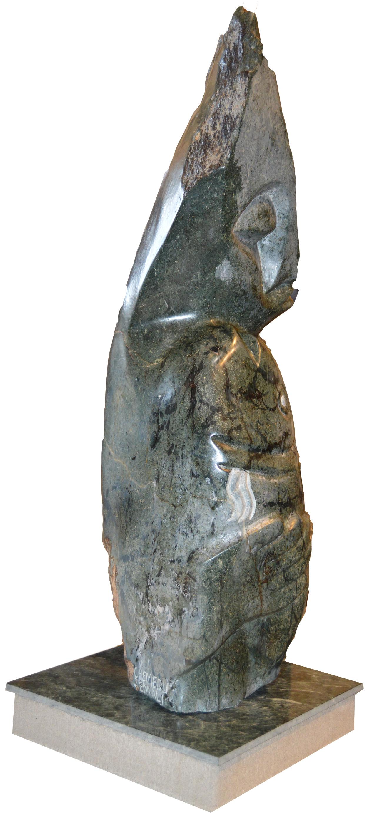 'Special Catch' is an original sculpture signed by the Zimbabwean artist Chemedu Jemali. The sculpture presents the head and torso of a figure clutching to a fish, each highly abstracted in Jemali's signature style: The figure's head leans to one