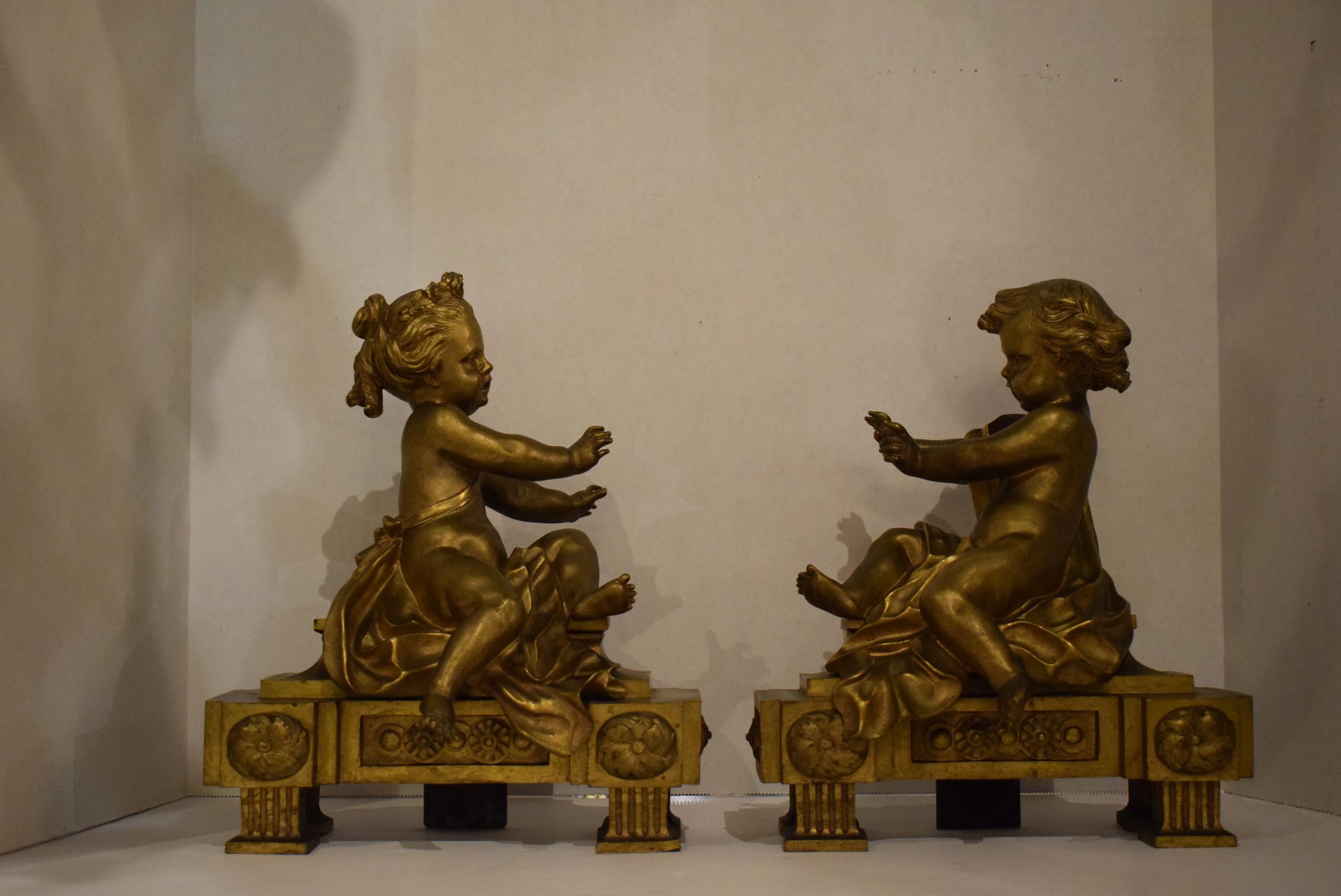 A very fine pair of gilt bronze chenets depicting a boy and a little girl warming up their hands by the fire. Exquisite quality.
Dimensions: Height 12