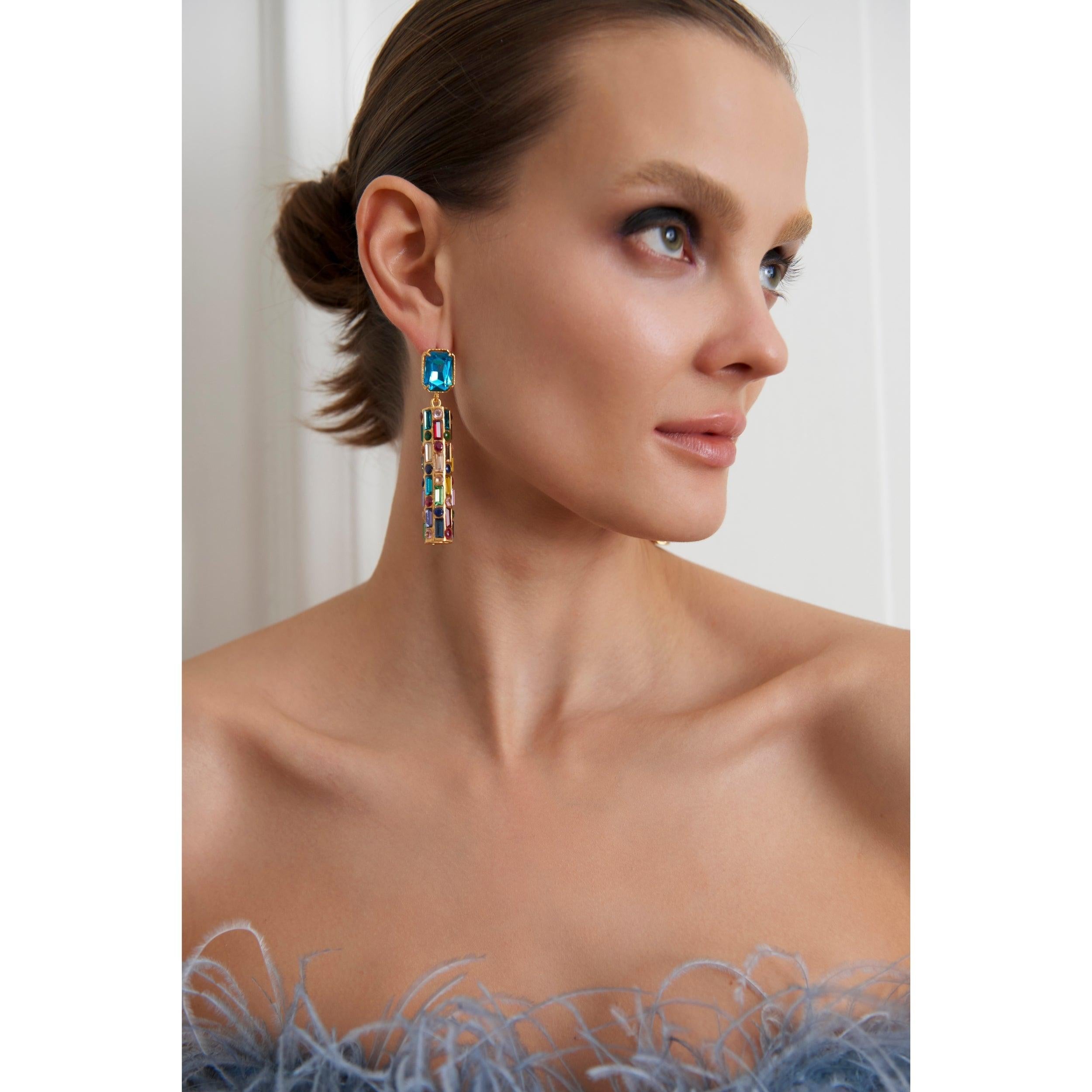 - **Unique Design**: The Cher Earrings feature an exceptionally unique design—cylindrical earrings adorned with various sizes of sparkling Swarovski stones, a style you won't find anywhere else.

- **Statement Piece**: Designed to make a bold