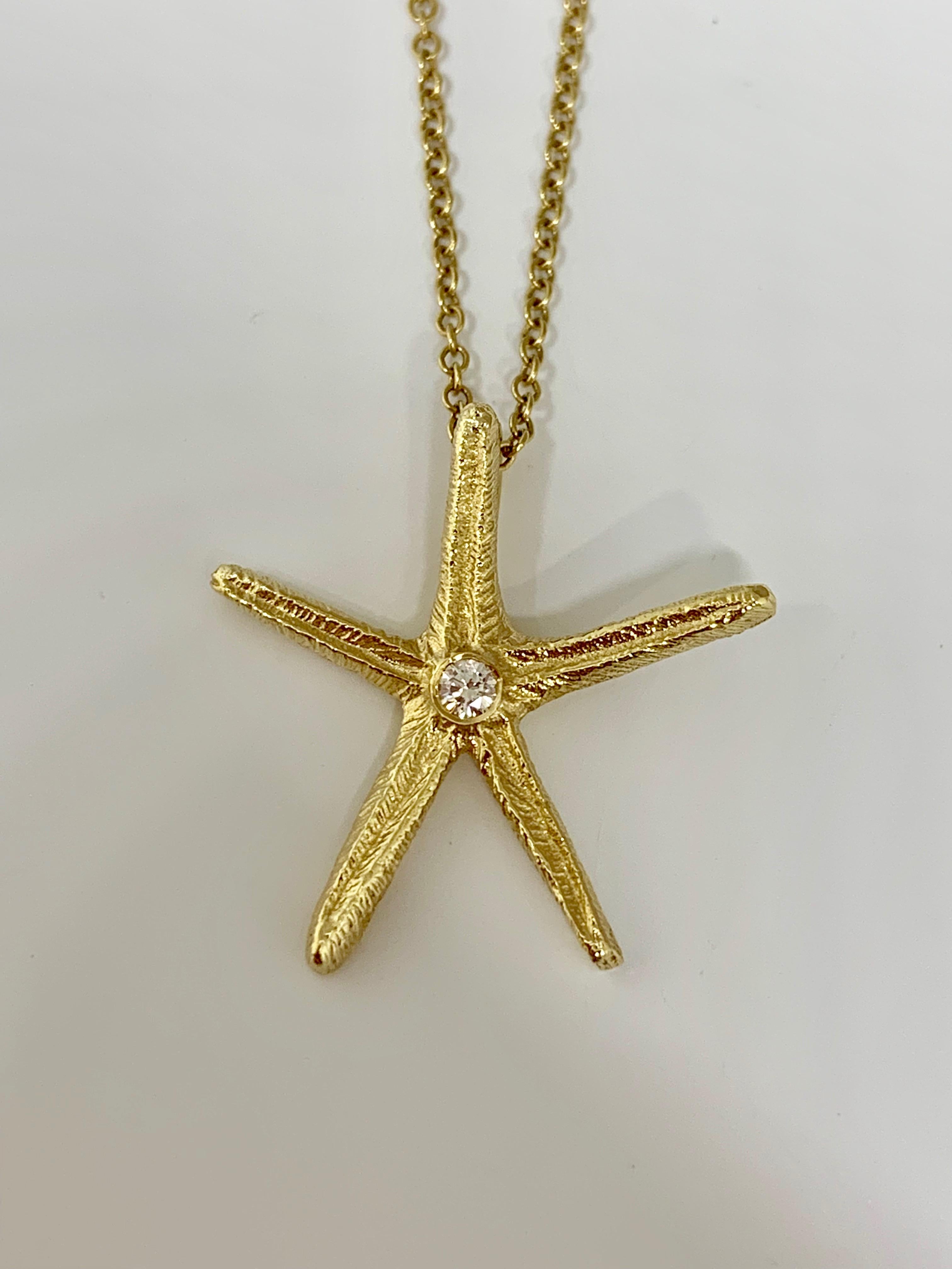 This gorgeous nautical style necklace features a single 0.05 carat round diamond in the center of the starfish along with beautiful texture throughout the body of the pendant. This necklace is made in 14K yellow gold and includes an 18 inch cable