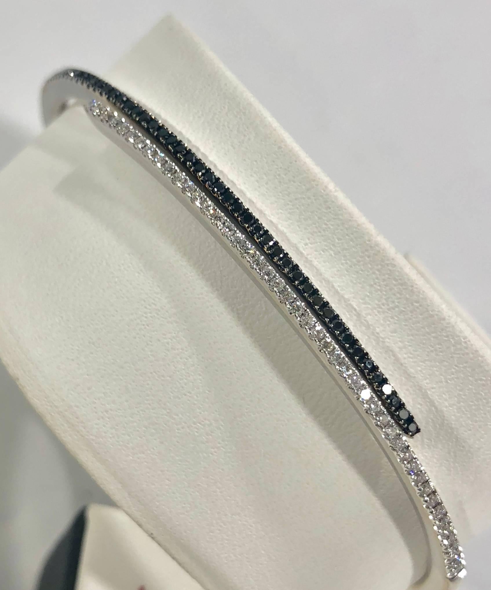 Cherie Dori 18 karat white gold and diamond cuff bracelet. This unique piece is created in 18 karat white gold, weight equaling 15.8 grams/ 10.1 dwt. There are 47 full cut round black diamonds equaling .25 carat total weight, and 47 full cut round