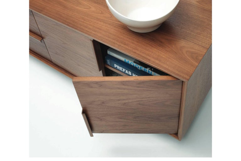 Multiflex casegoods are lightweight, strong and made entirely from laminated, cross-ply and molded plywood. Clear or Classic finish on American Walnut veneers are complimented by the exposed mitered and curved plys of the geometric case and molded