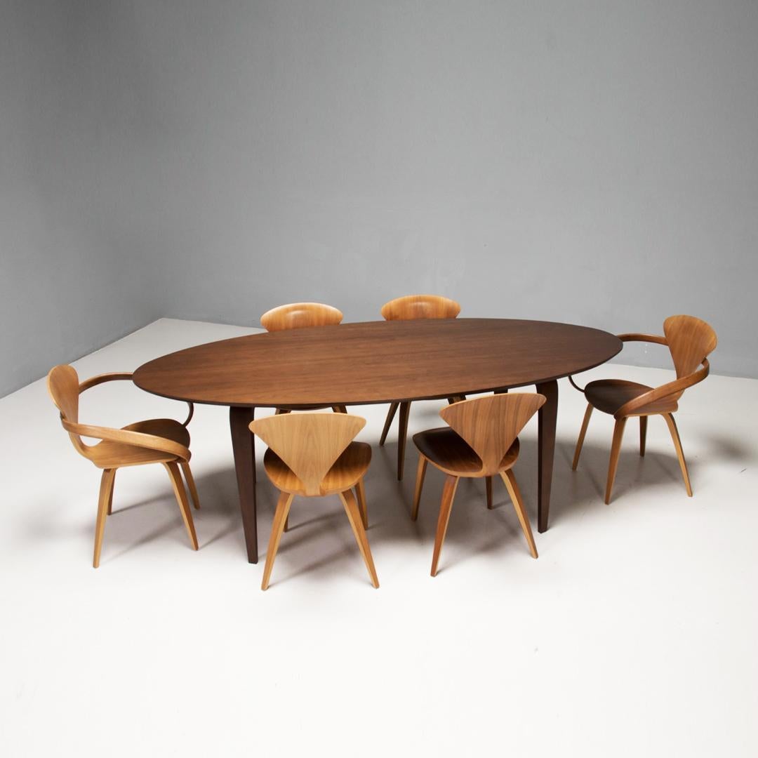 This Oval dining table and set of six chairs was manufactured by the Cherner company in 2013.

Originally designed by Norman Cherner in 1958, the Cherner carver chair has since become one of the most iconic designs of the 20th century.

In 1999