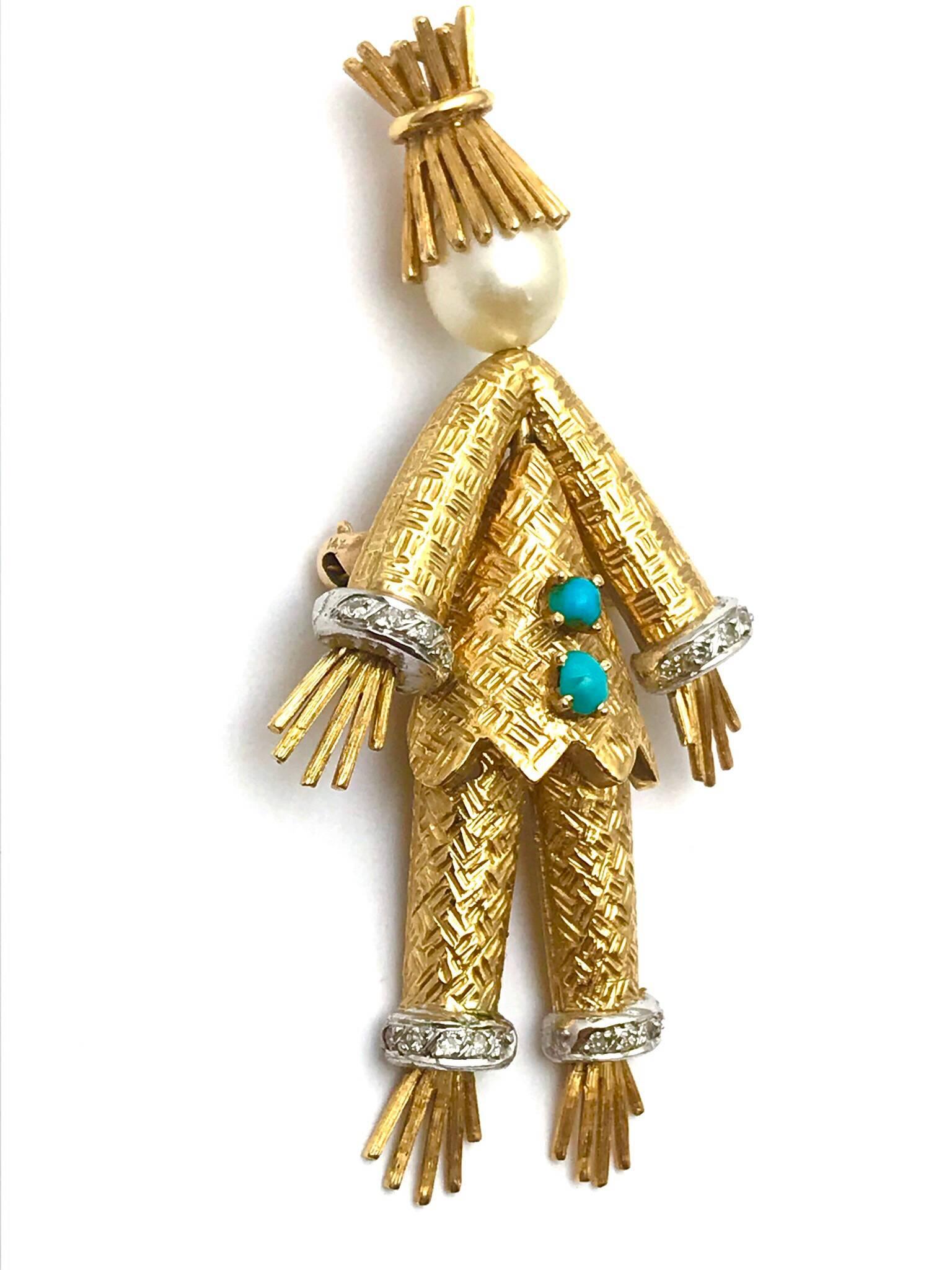 A Cherny cultured pearl, diamond and turquoise 18 karat yellow gold scare crow brooch.  The scare crow is wearing a textured gold suit, with diamond cuffs on the arms and pant legs, a straw hat, with straw hands and feet, and two turquoise buttons