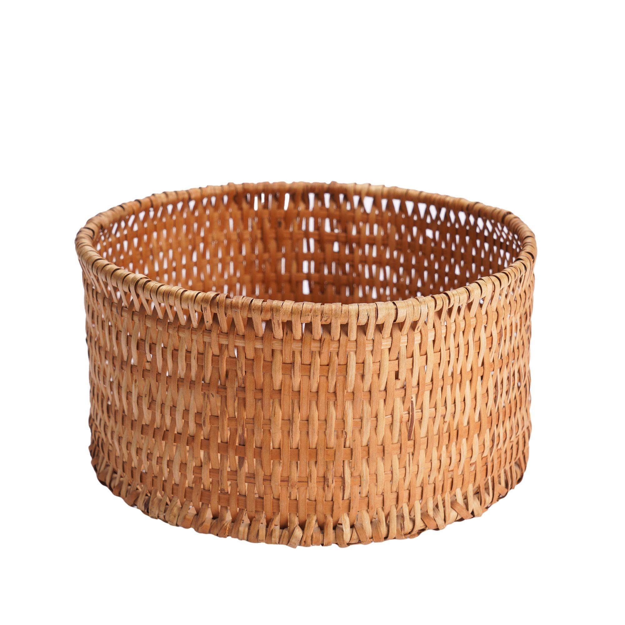 This Cherokee cylinder basket is framed by two carved and bent circular dowels, both at the top and bottom of the basket. Between are 1/8