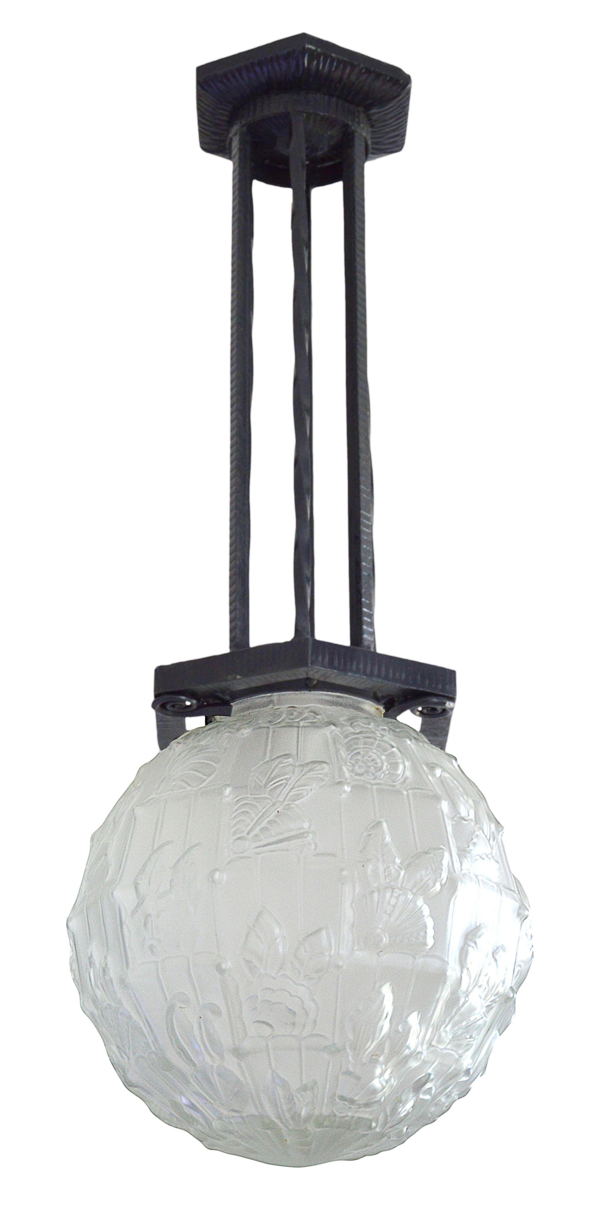 French Art Deco ceiling-light by Cherrier & Besnus, 36 rue Amelot, Paris, France, ca.1925. Large molded glass shade showing a stylized floral pattern hung on its wrought-iron fixture. Measures: Height: 65cm (25.6