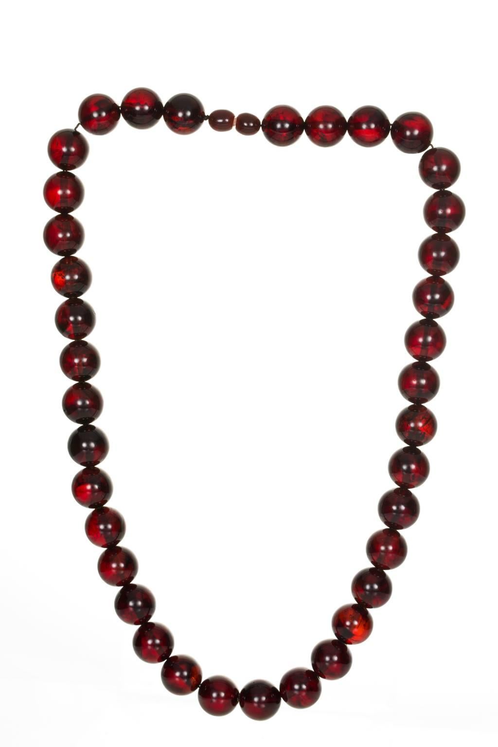 Deep rich tones of dark cherry red and golden brown, these 37 beads of amber make up the most gorgeous necklace. The beads are approximately 12mm in diameter and are fastened with a screw amber bead clasp. The necklace is 19 inches in length - 47 cm