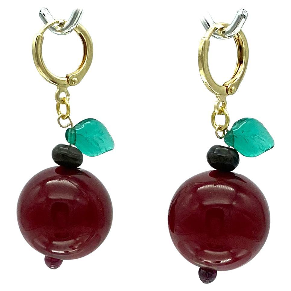 We created this fun set of dangle earrings with 19mm large cherry color bakelite balls and molded green glass leaves. They are linked with gold filled 14mm round lever back ear wires.

Our vintage jewelry collection and original creations are all