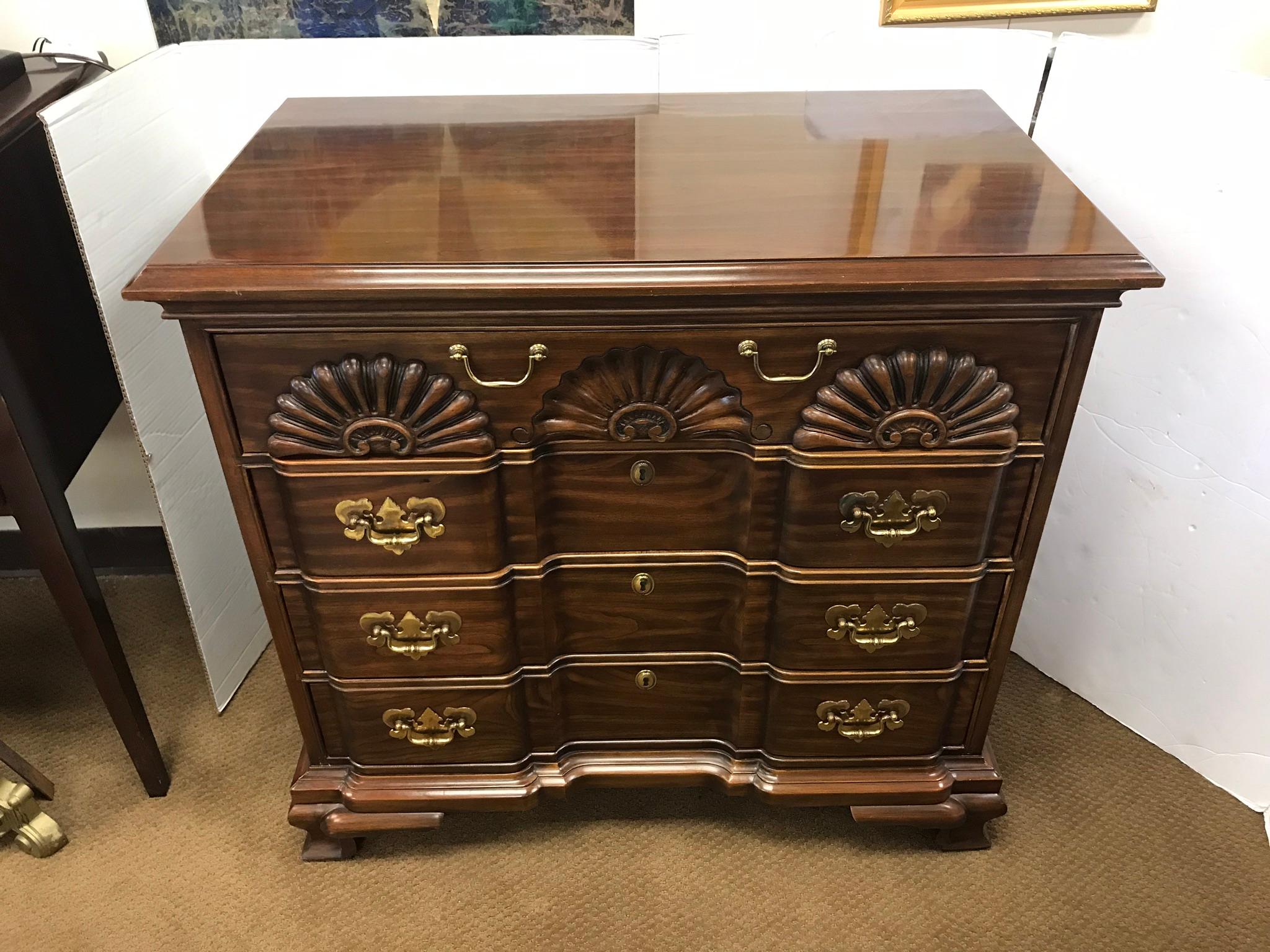 Classic four drawer dark cherry dresser complete with shell carvings at top drawer, circa 1980s.