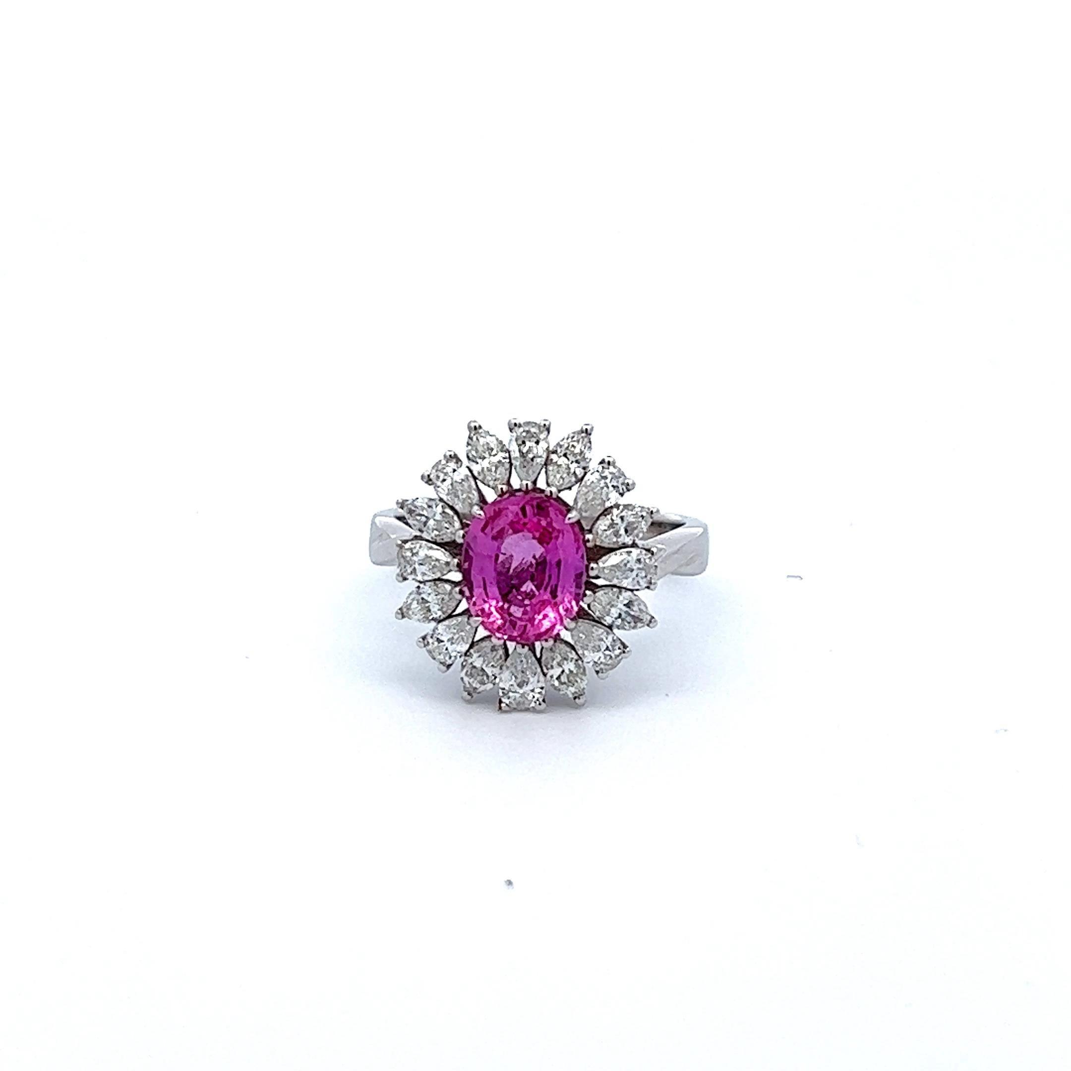 Introducing the Cherry Blossom Pink Sapphire and Diamond Ring, a stunning piece of jewelry inspired by the beauty and grace of Japanese cherry blossoms. This exquisite ring features a rare, natural oval-shaped pink sapphire weighing 2.27 carats,