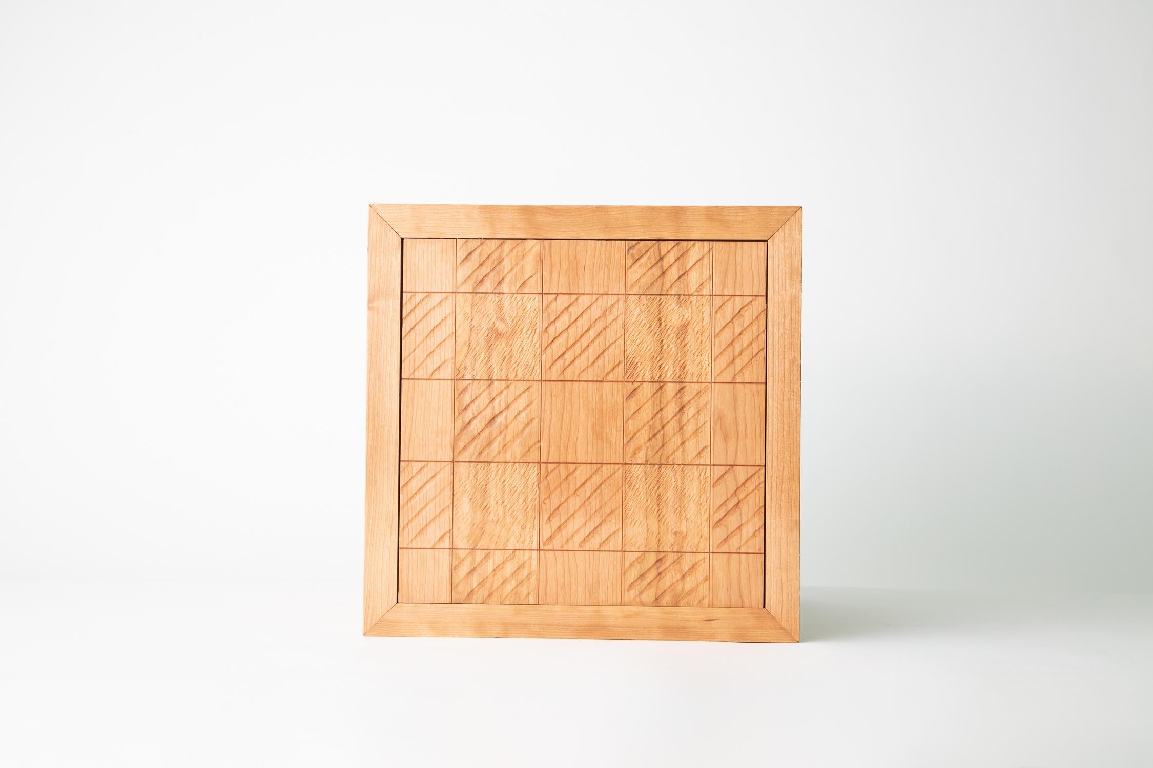 Carved Lines wooden cube, Cherry Buffalo Plaid

Noah James Spencer's Wooden Cubes are minimalist sculptures. Made in plain or carved patterned wood, they easily stand alone in a room, yet in multiples they become taller towers or room dividers.