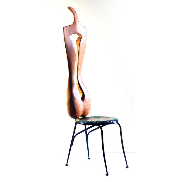 Inspired by the sensuality of the female form, this exclusive chair is entirely crafted by hand with four slender powder-coated steel legs supporting a round wooden seat showcasing inserts of genuine leaves set in place by a coat of epoxy resin. The