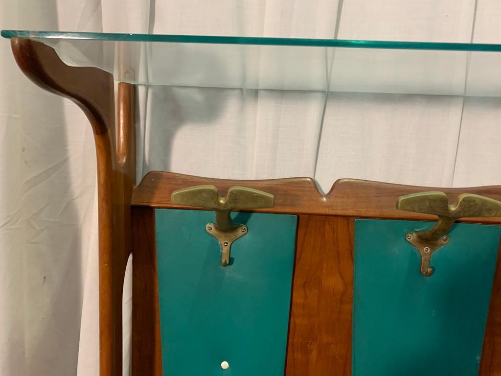 1950's coat rack in cherry and green leatherette, glass hat rest platform brass details.