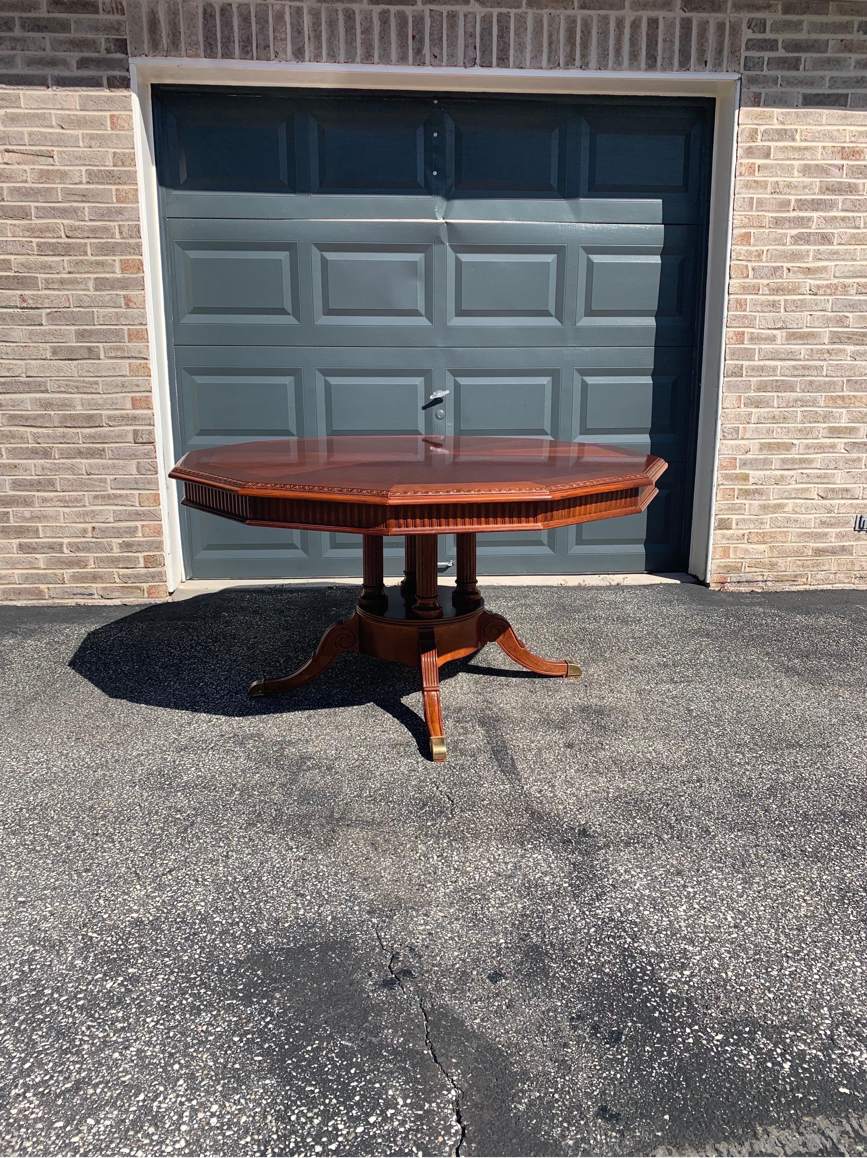 Elegant and classic dodecagon 12 sided cherry inlaid table by Universal Furniture. Cherry inlaid tabletop with egg and dart edging, pie cut cherry field, brass capped feet with four fluted columns atop the pedestal base. Table is very sturdy and