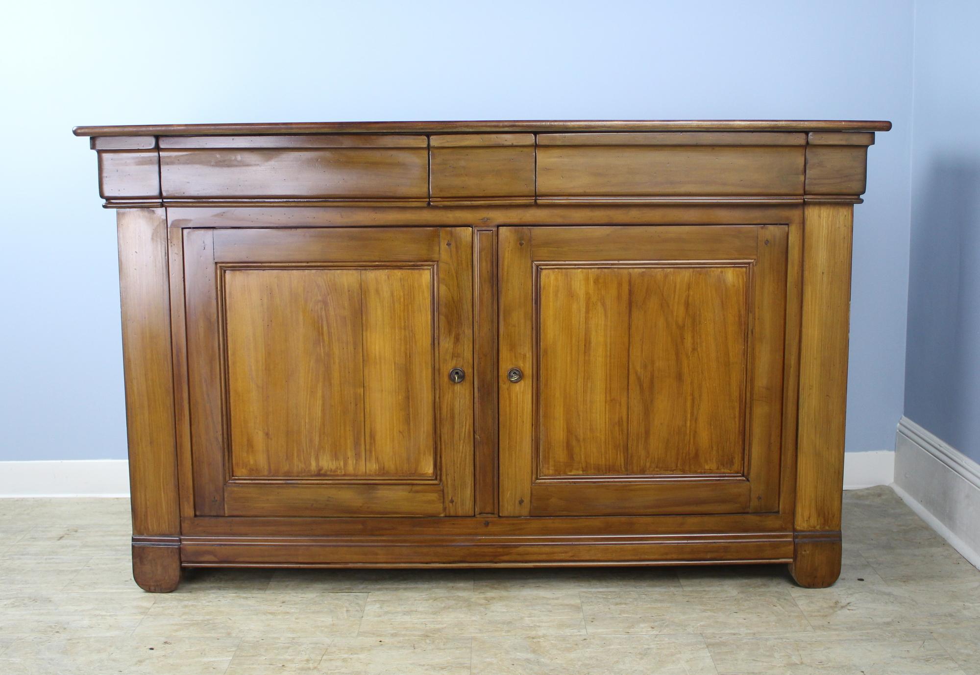 Custom made for Briggs House in France of old wood, this is a wonderful example of the Louis Philippe style, with shaped drawers, set-in panels on the doors and sides, and perfectly shaped bottom moldings, which are very lovely. The lighter, warm