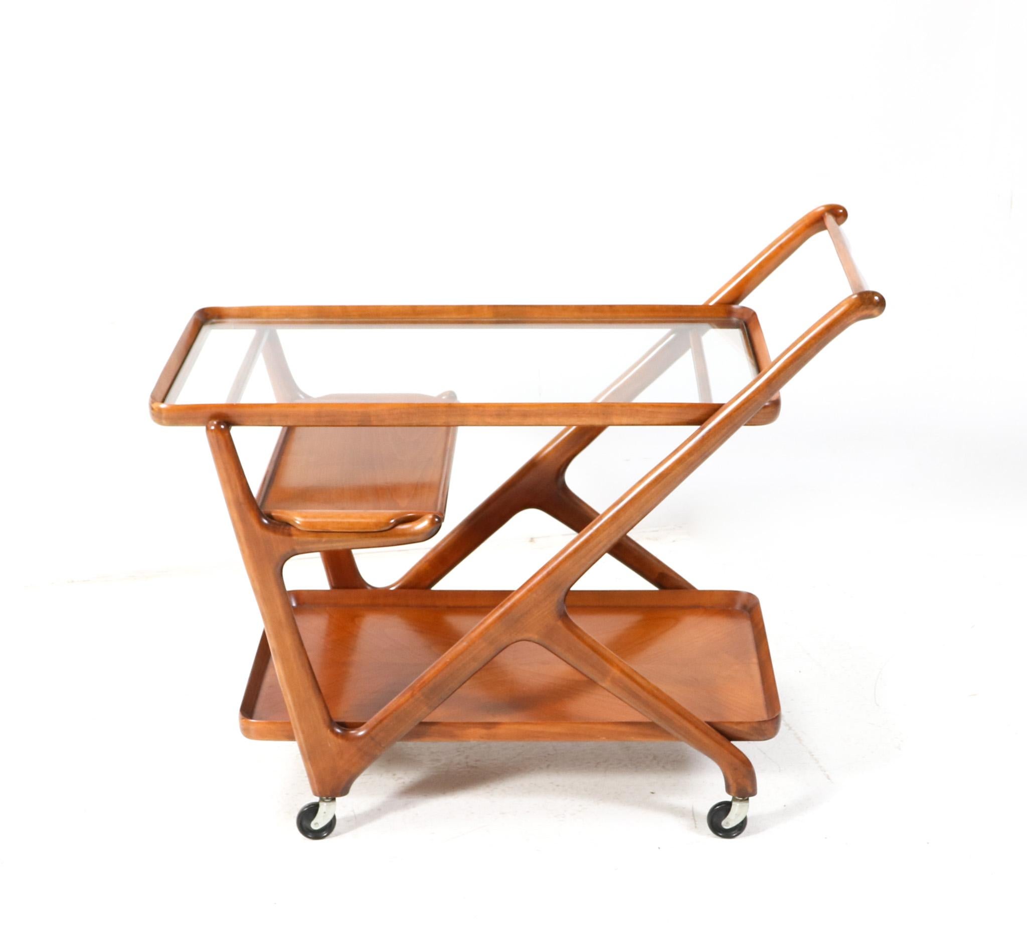 Stunning and elegant Mid-Century Modern trolley or bar cart.
Design by Cesare Lacca for Cassina.
Striking Italian design from the 1950s.
Solid cherry sculptural frame with the original removable small serving tray,
which is hard to find!
Original