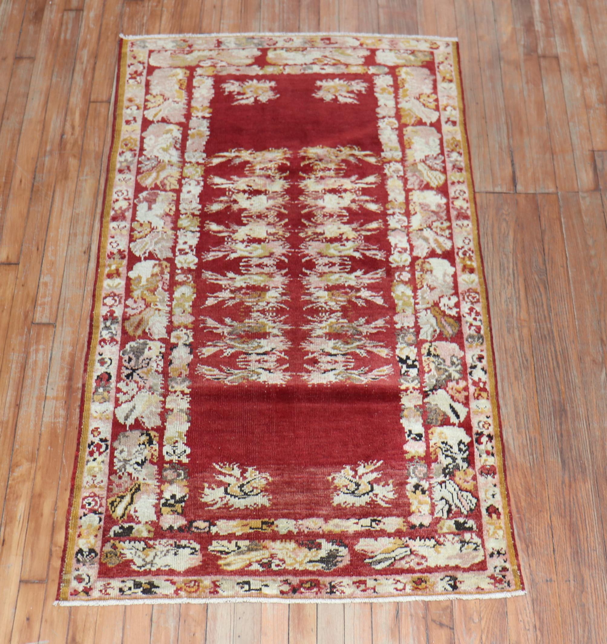 A finely woven Turkish rug executed with pristine jewel-tone colors. A cherry red open field spacious motif. The floral elegantly flows with the rest of the motif. The craftsmanship on this is superb. Might even be a great wall piece.

Measures: