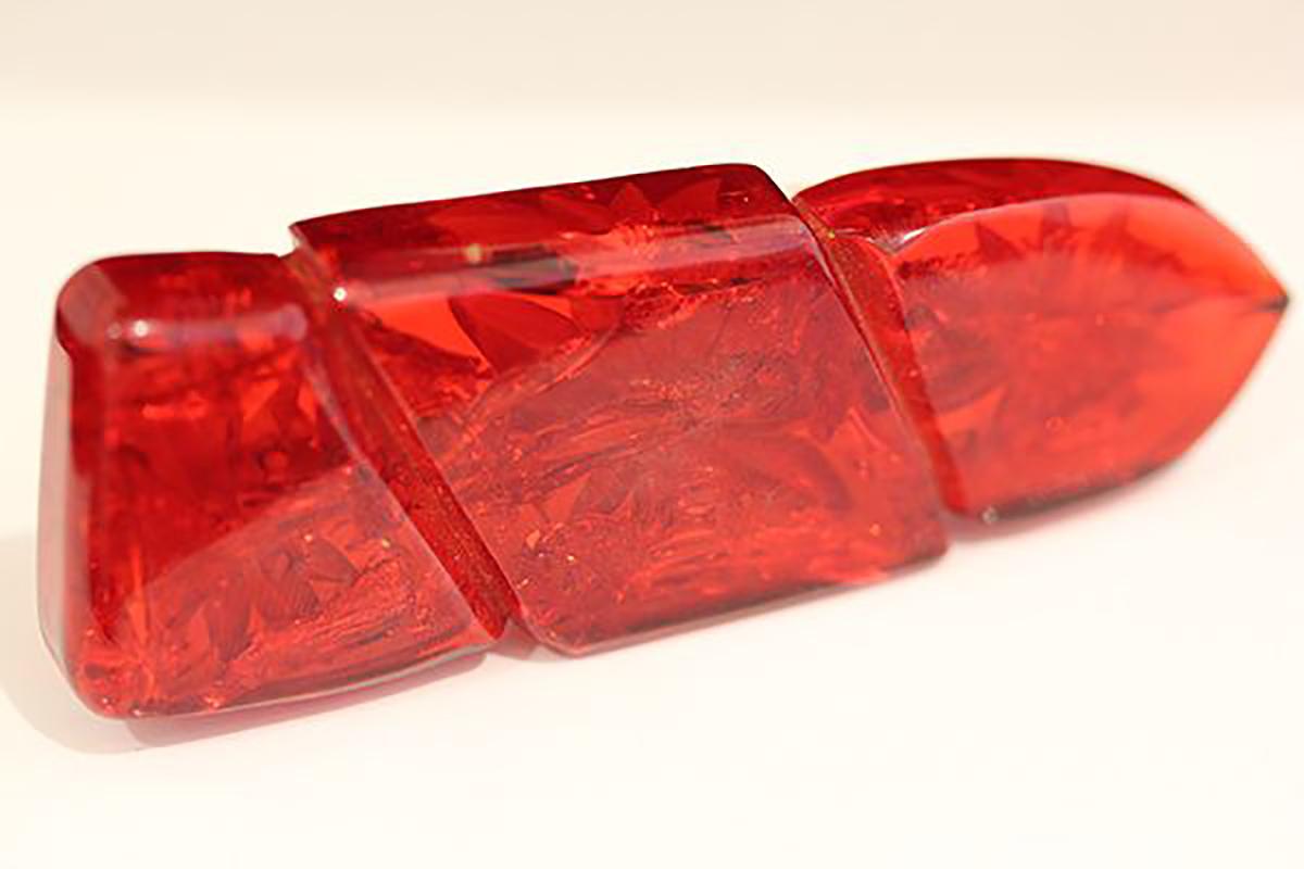 Cherry Red, reverse carved Bakelite brooch with Fern Like inclusions as in Amber, Art Deco, C1930's.  As you look inside of the transparent Cherry Bakelite you can see that they have put plant matter into the Bakelite during the curing process.  