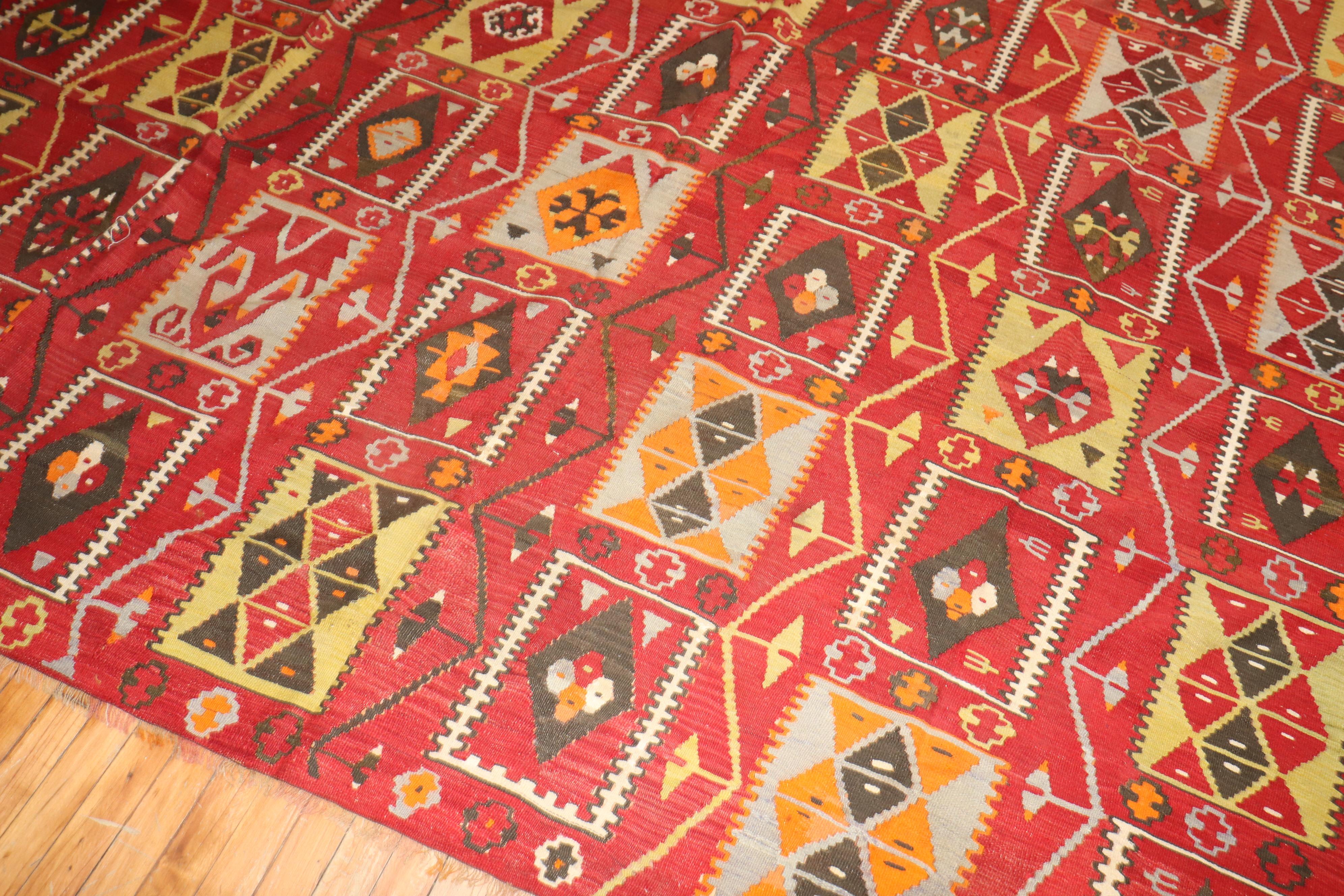 Vintage Turkish Kilim with a colorful repetitive square design on a cherry red colored ground.

Measures: 8'10
