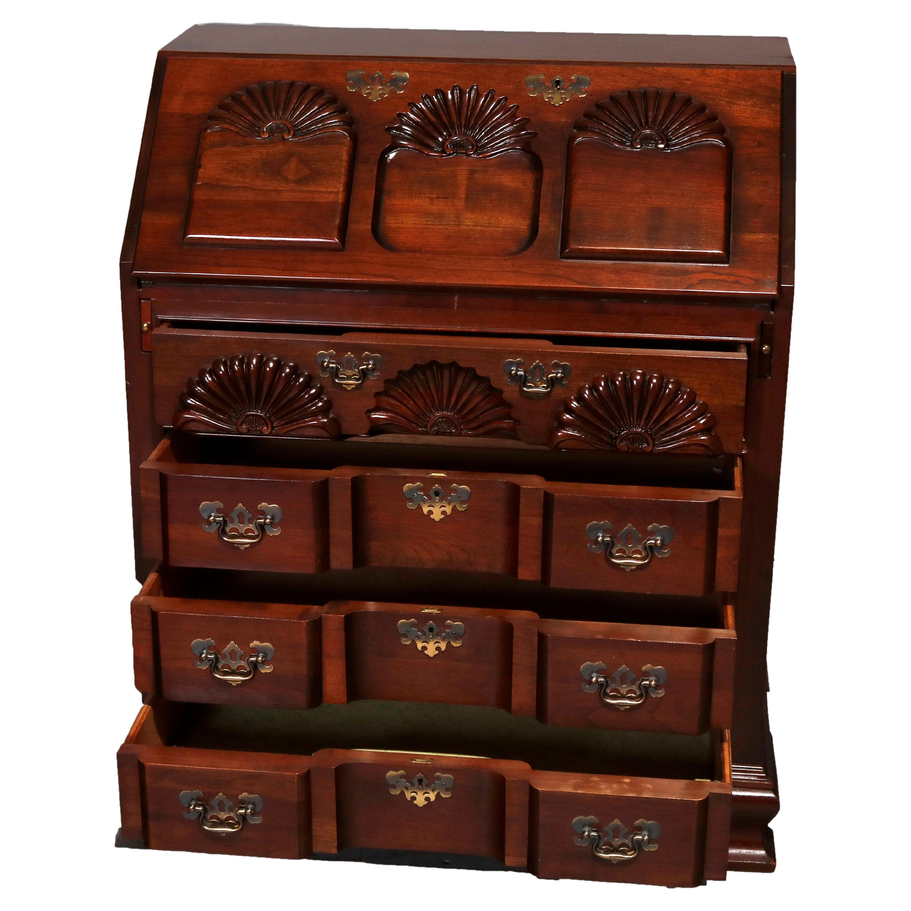 A Chippendale style desk offers cherry construction with drop front over block case having four drawers, shell carved reserves throughout, raised on bracket feet, 20th century

Measures - 37.5