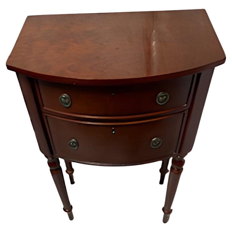 French 2 Drawer Mahogany Nightstand/End Table w/ Fluted Legs – 

Elegant and timeless, this vintage Demilune table features a rich mahogany finish, two curved drawers with antique brass pulls, and classic fluted legs. Perfect as a bedside nightstand
