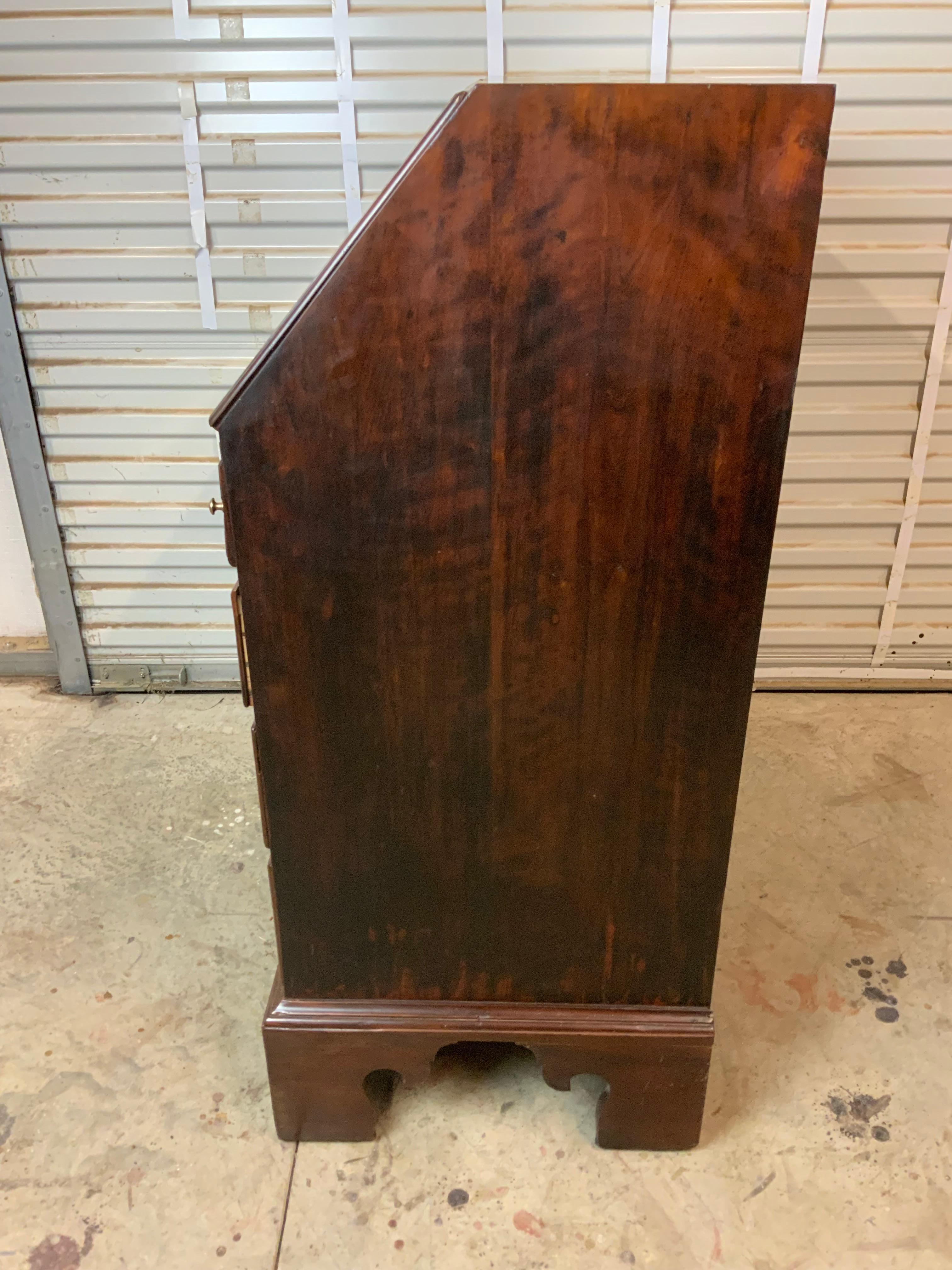 A nice early 19th century Cherry slant front desk probably Pennsylvania or Virginia.  Nicely dovetailed case resting on tall bracket feet.  The interior surface is fitted with several small drawers and a locking lid with three smaller drawers behind