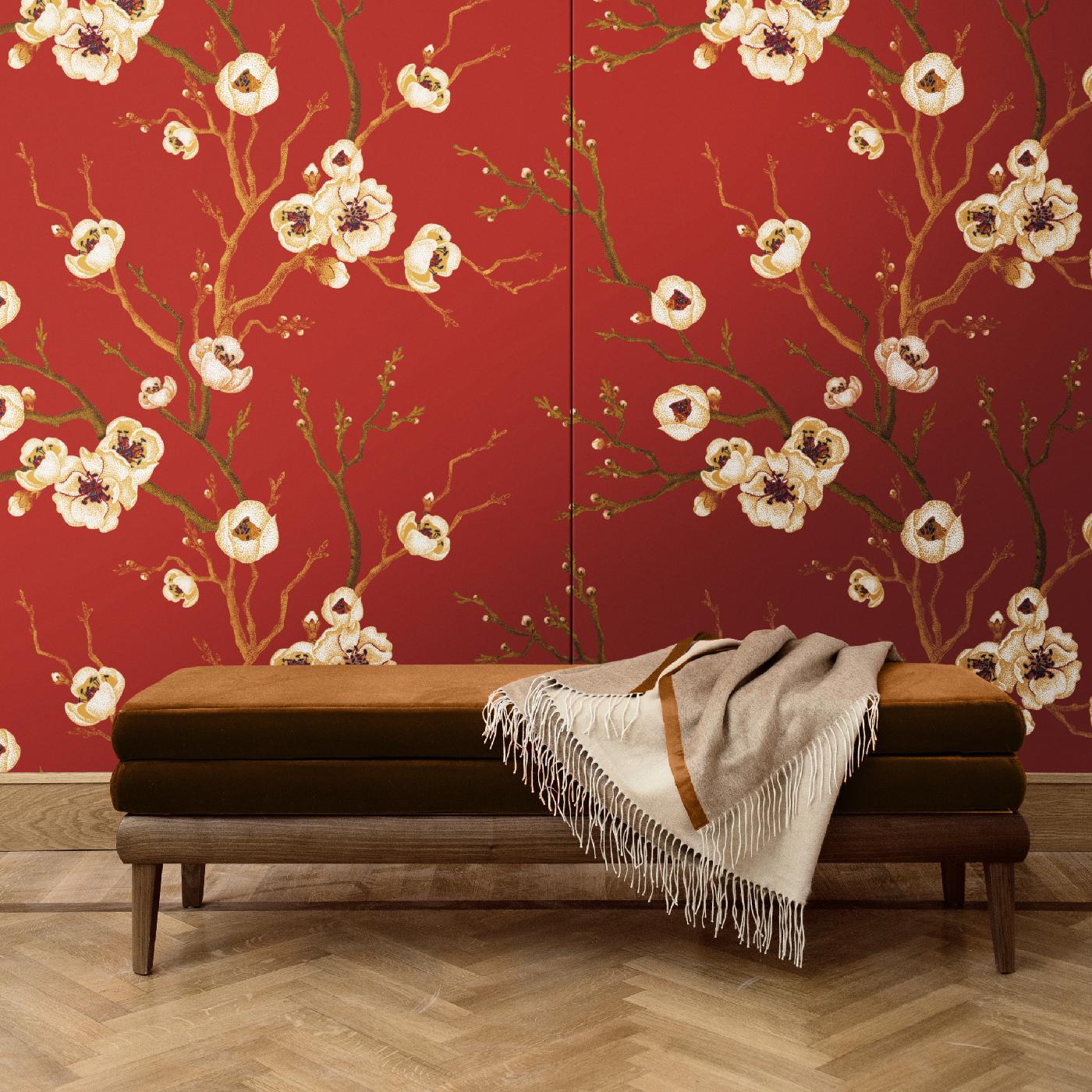 Part of a series of cherry blossom wall covering that will add a precious and timeless decoration to any interior, this piece is available both as boiserie, with a wood honeycomb structure, and as fabric. Featuring the same design of a vivid red