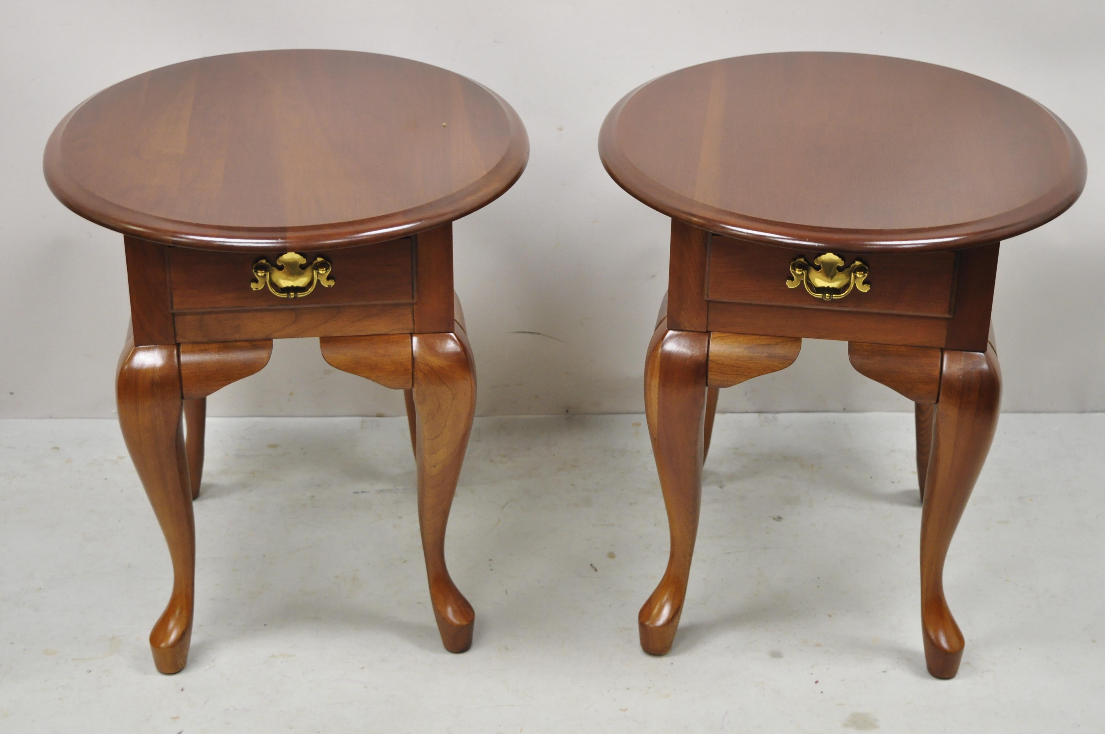 Cherry wood Queen Anne one drawer oval lamp side end tables - a pair. Item features oval top, solid cherry wood construction, beautiful wood grain, 1 dovetailed drawer, shapely Queen Anne legs, solid brass hardware, quality American craftsmanship.