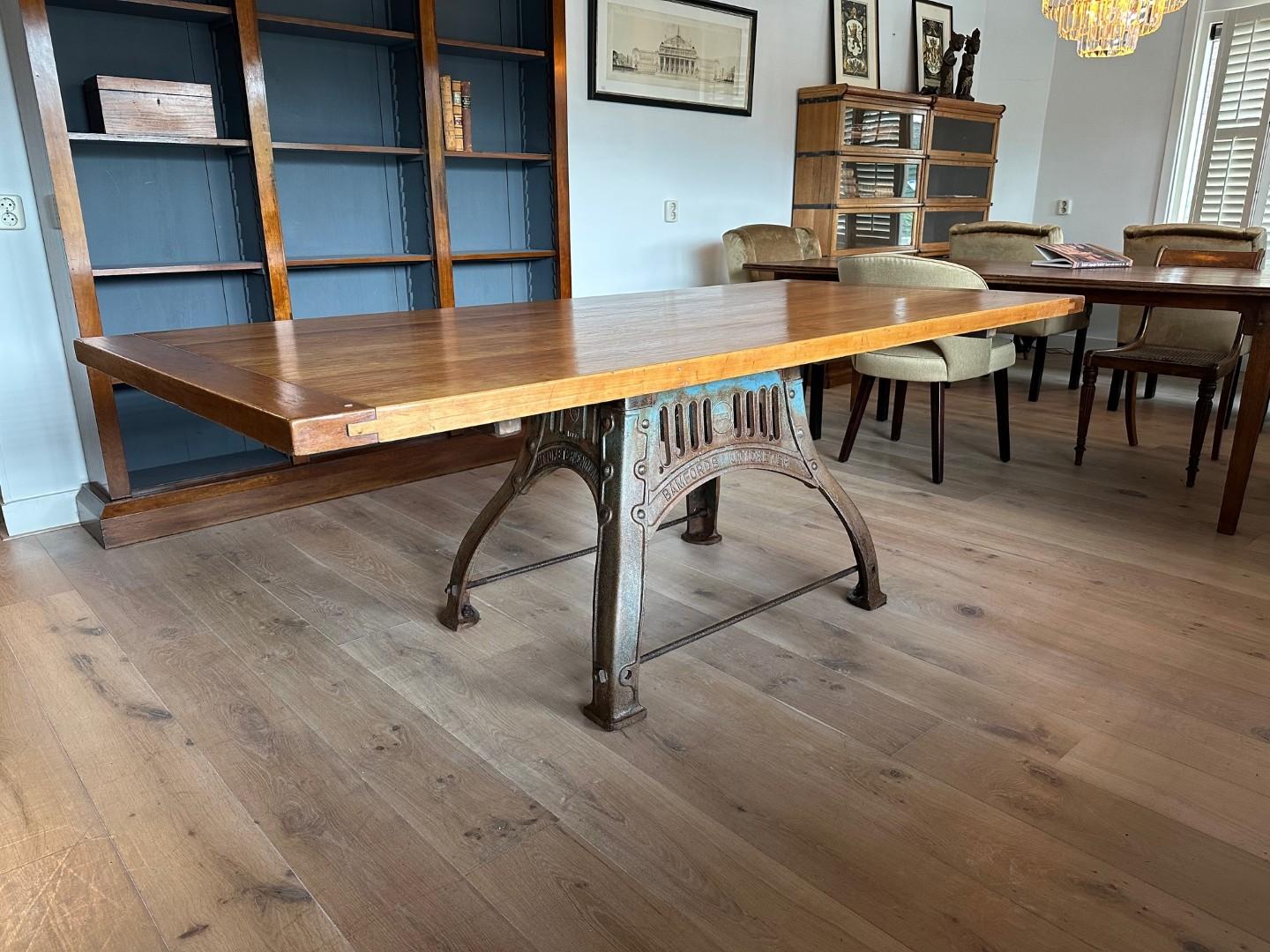 Early 20th Century Cherry wood table on old cast iron base For Sale