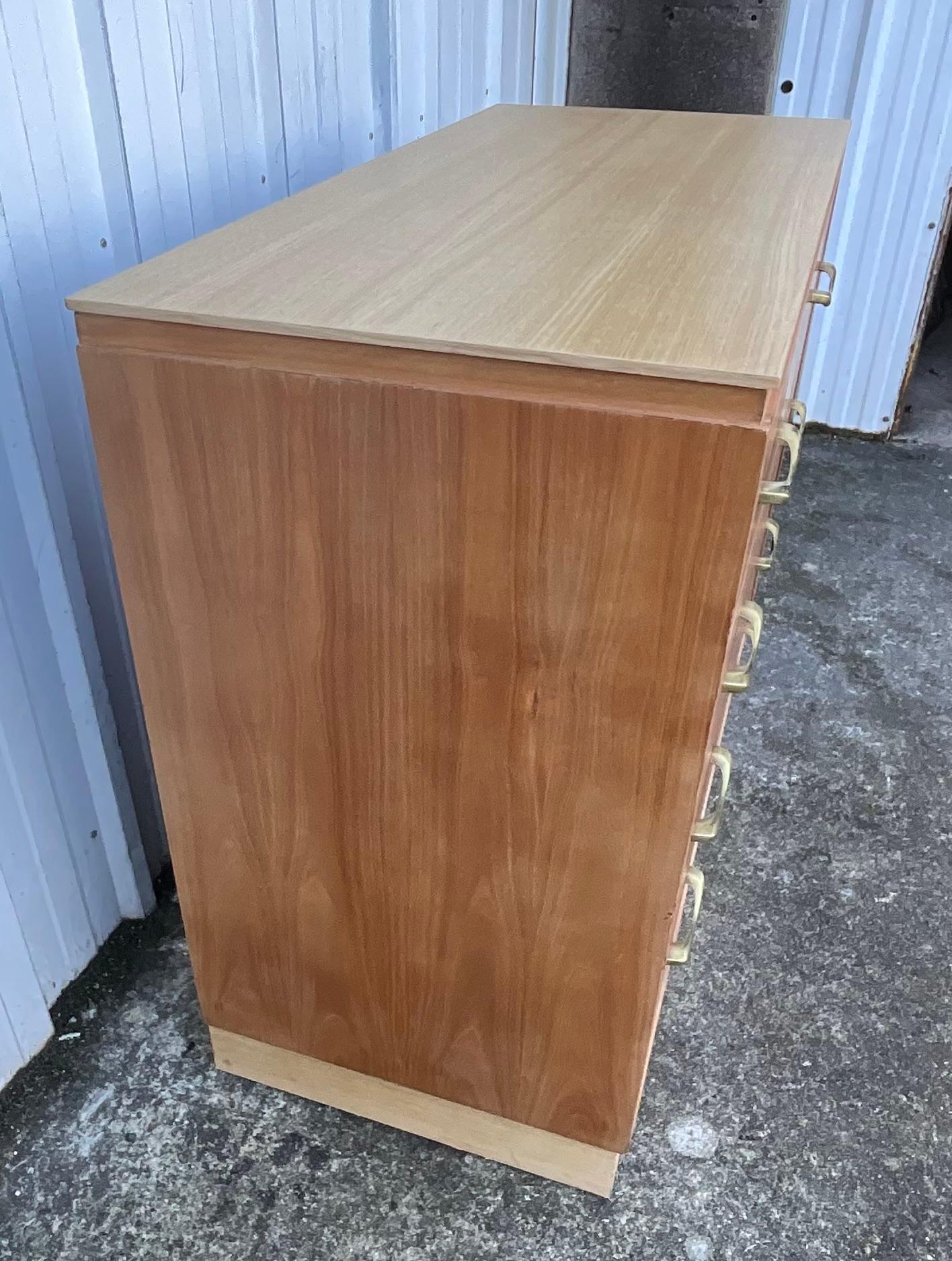 Questa magnifica cassettiera in ciliegio, realizzata nella raffinata tradizione dell'ebanisteria, è una vera e propria erede dello stile Art Déco, che incarna l'eleganza e la raffinatezza di un'epoca in cui i mobili venivano progettati come vere e